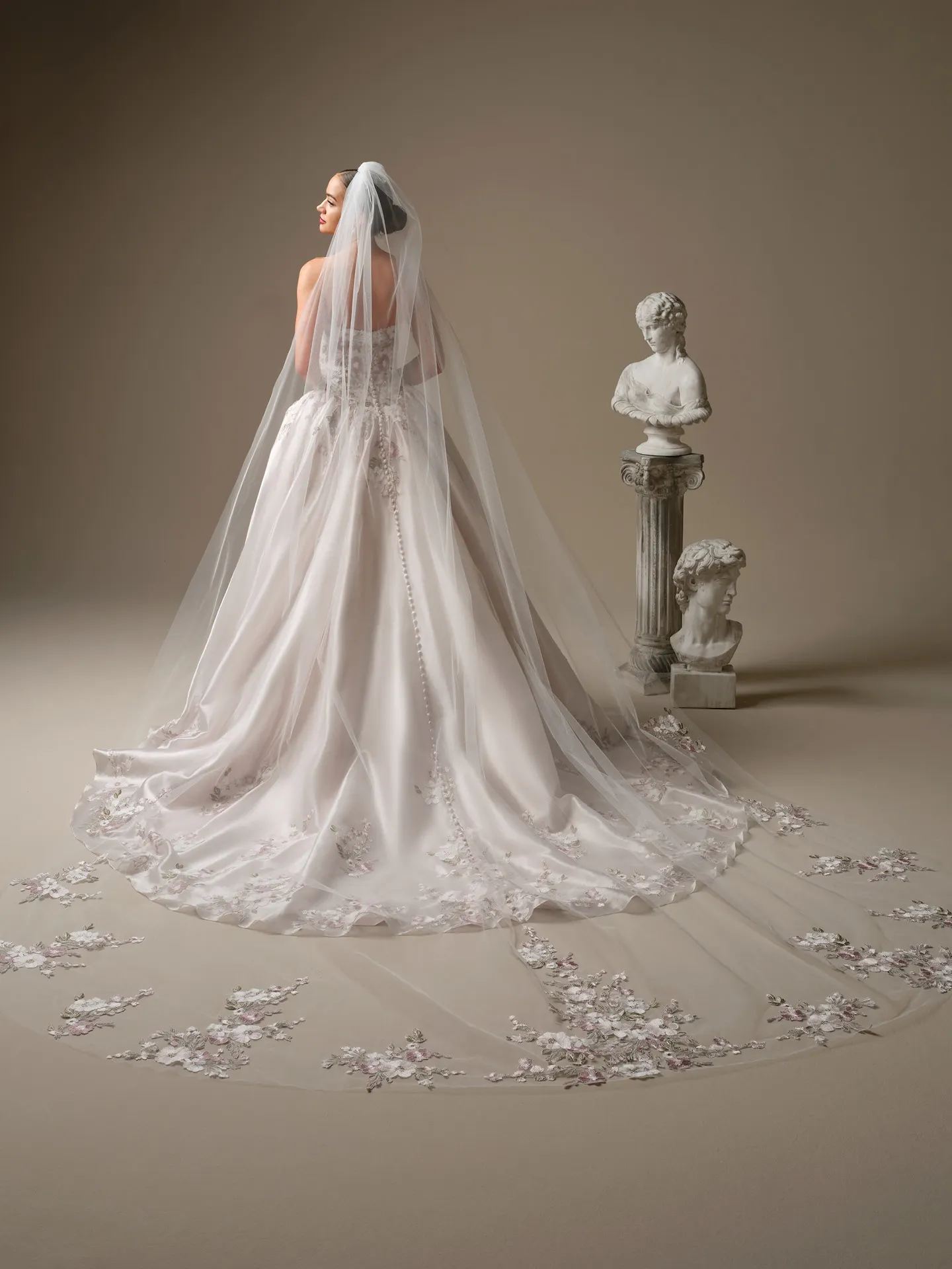 Maggie Sottero Alvarez, back view floral lace ballgown with long veil.