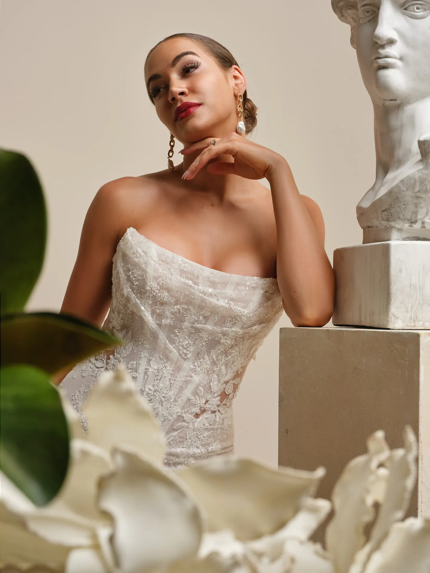 Sottero and Midgley Dublin lace sheath dress with statue background.