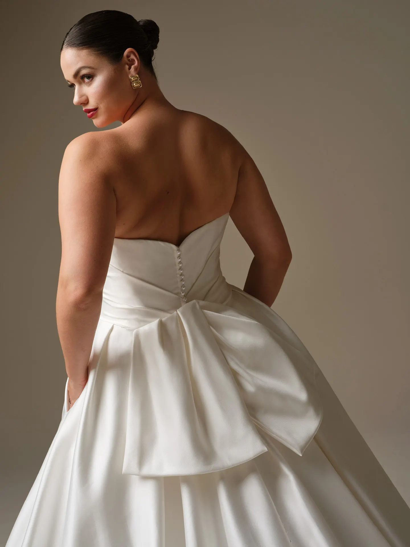 Sottero and Midgley Kincaid, back view satin ballgown with bow detail.