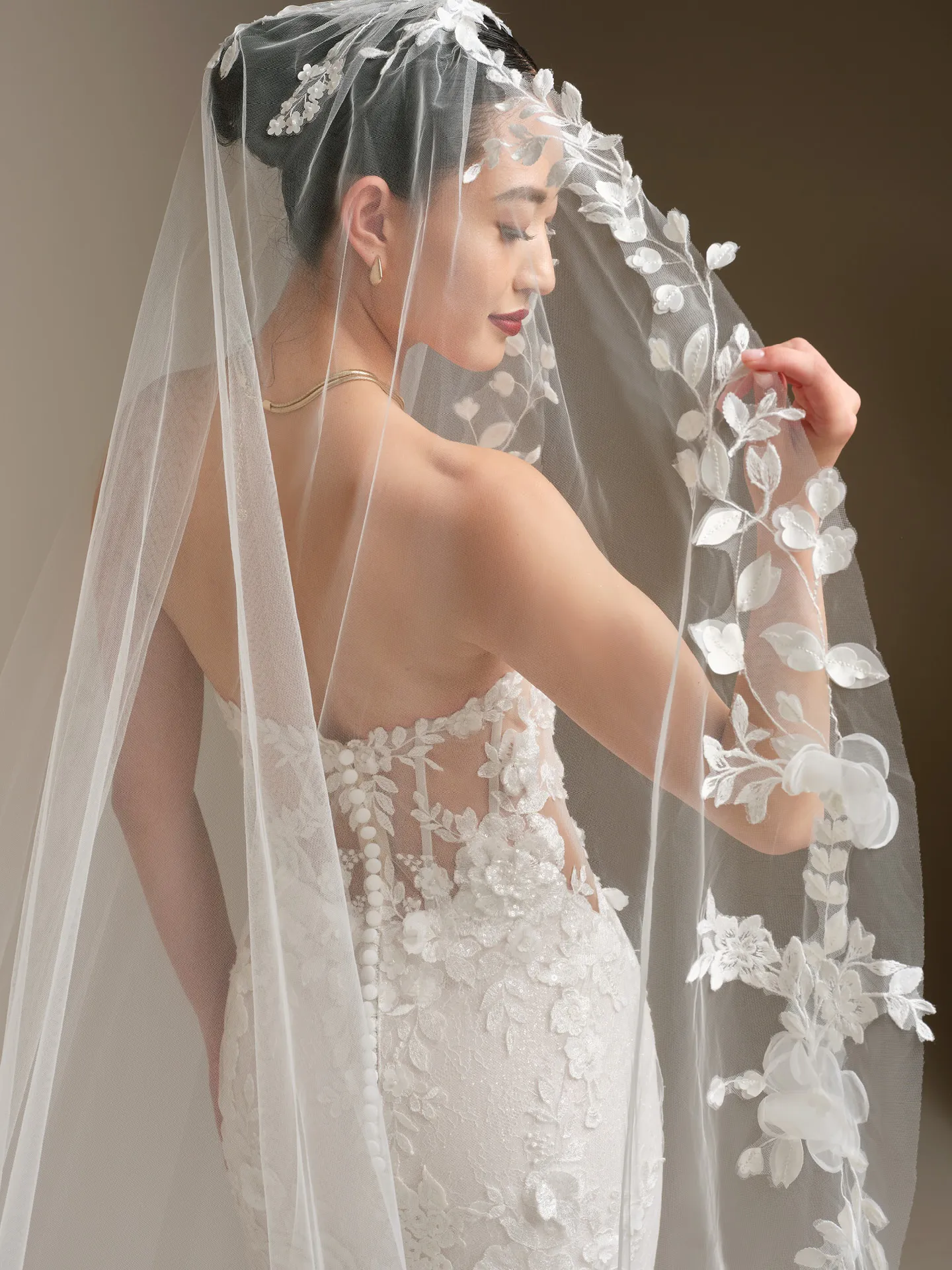 Sottero and Midgley Rashida, back view lace fit-and-flare dress with floral veil.