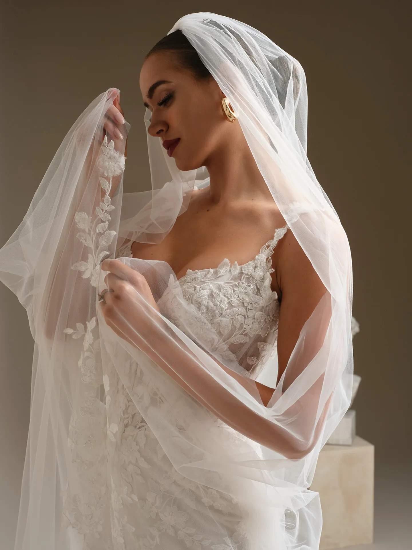 Sottero and Midgley West, side view lace fit-and-flare dress with veil.