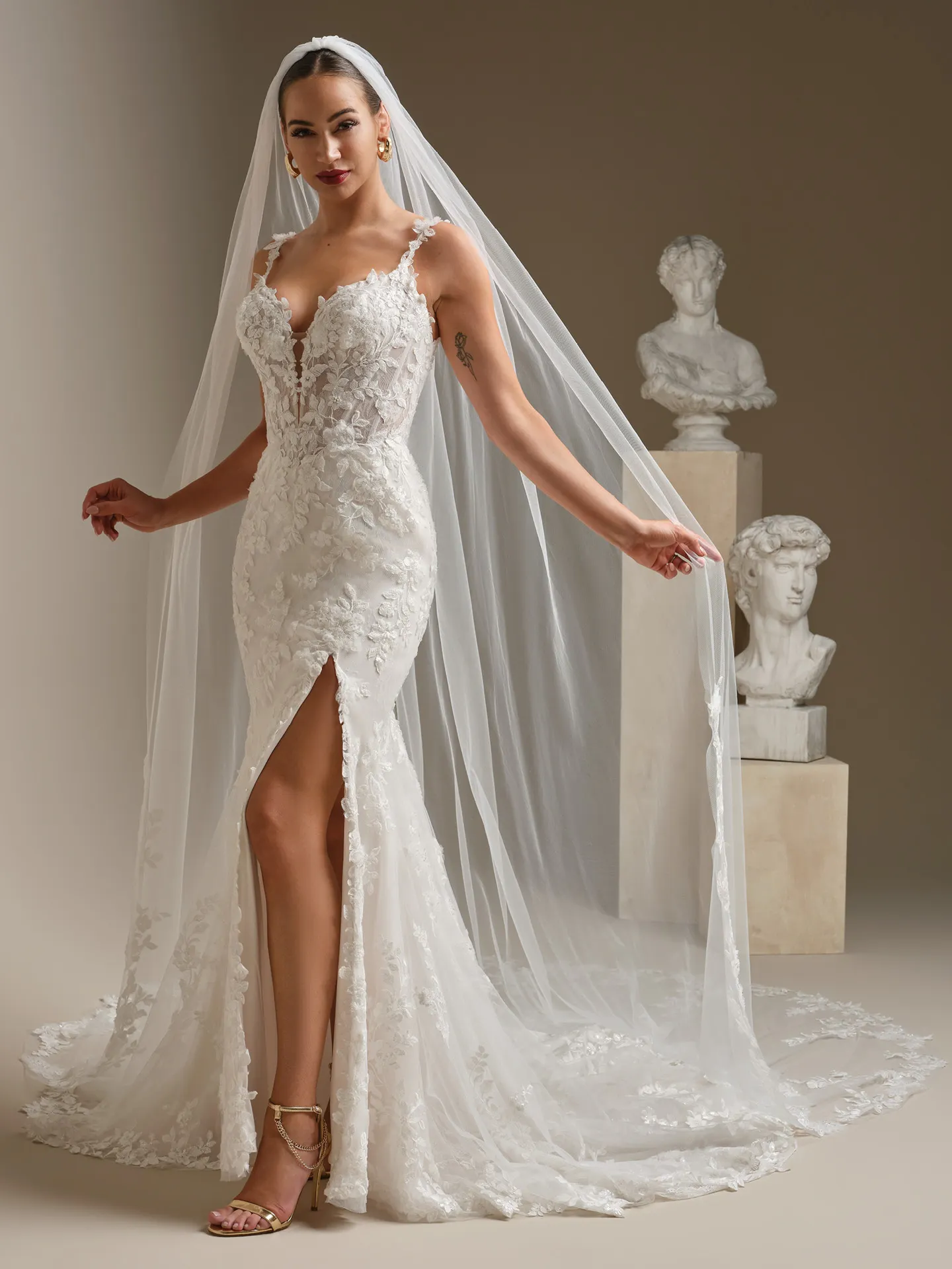 Sottero and Midgley West, front view beaded lace fit-and-flare wedding dress with veil.