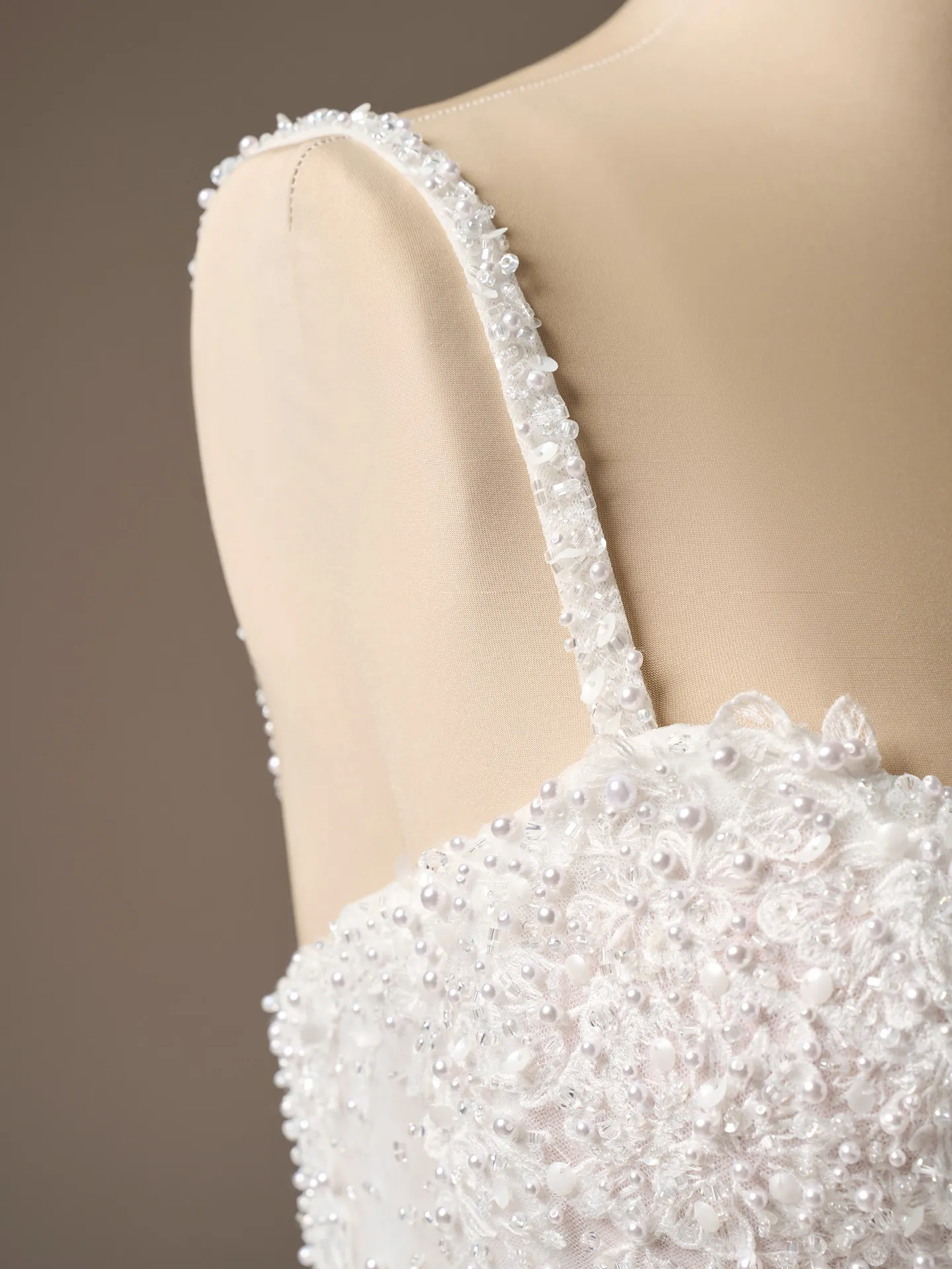 Maggie Sottero London strap beaded lace detail close-up.