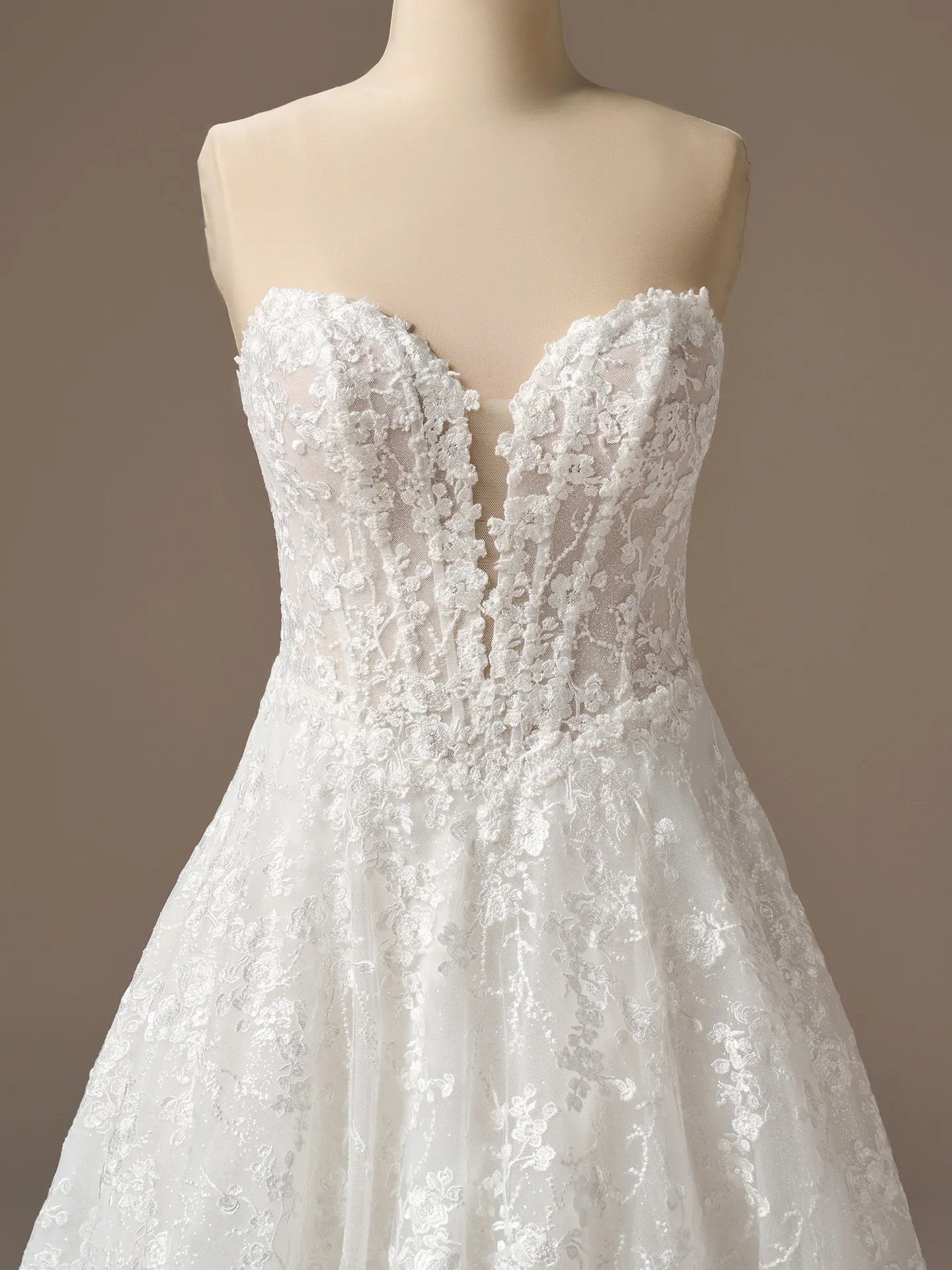 Maggie Sottero Memphis A-Line dress, front view with plunging neck and floral lace.