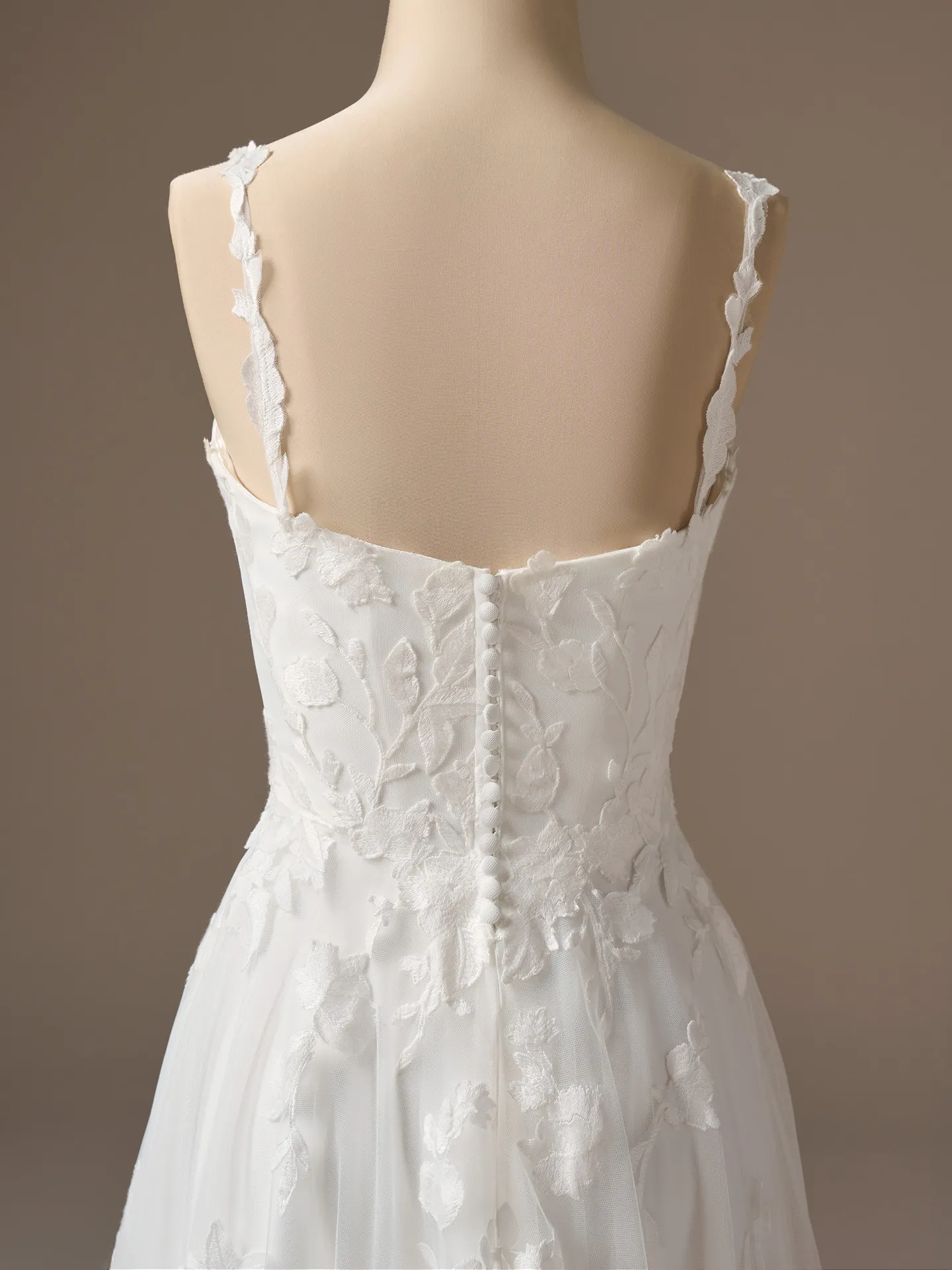Maggie Sottero Natalie, back view floral A-line dress showing button detail.