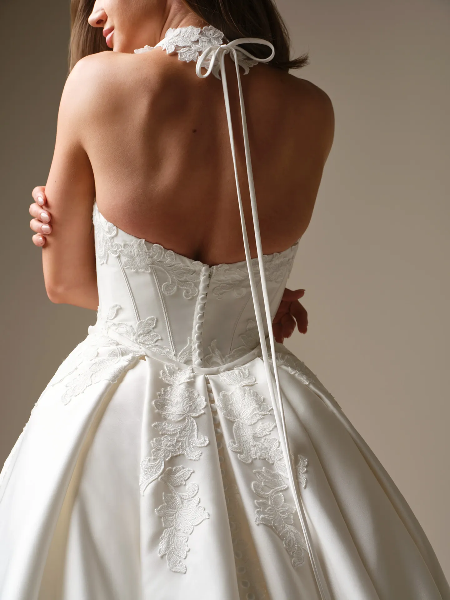 Serafina satin ball gown, back view with lace and button details.