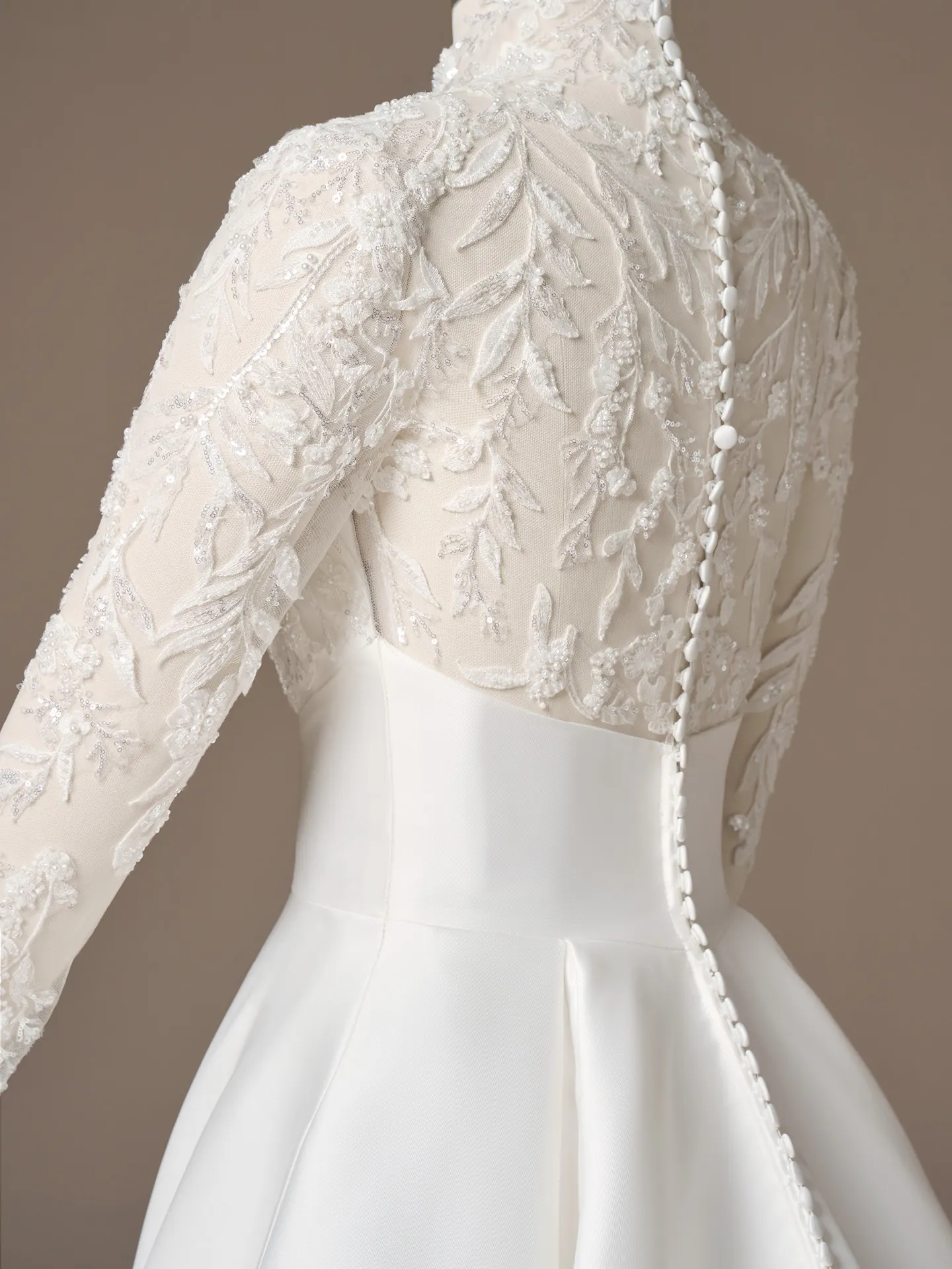 Maggie Sottero Trinity, back view with lace sleeves and button detail.