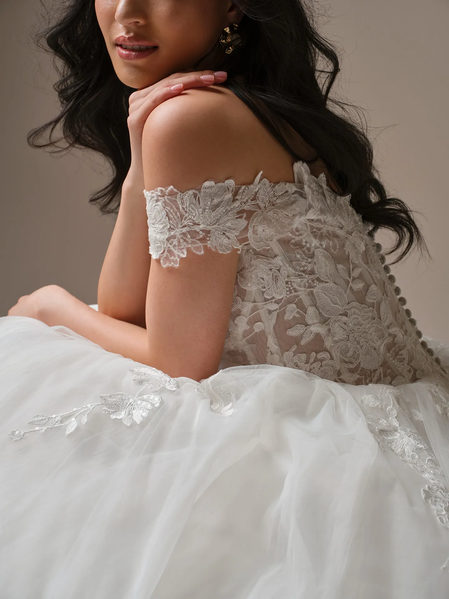 Maggie Sottero Verina off-shoulder lace A-line wedding dress side view.