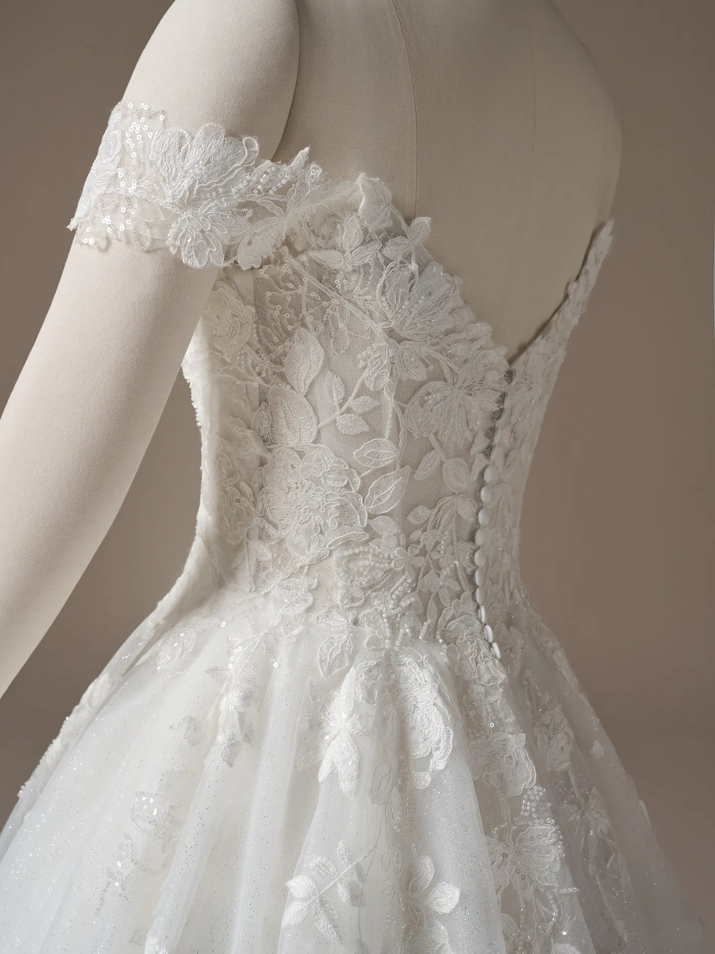 Maggie Sottero Verina off-shoulder lace A-line dress, side view.