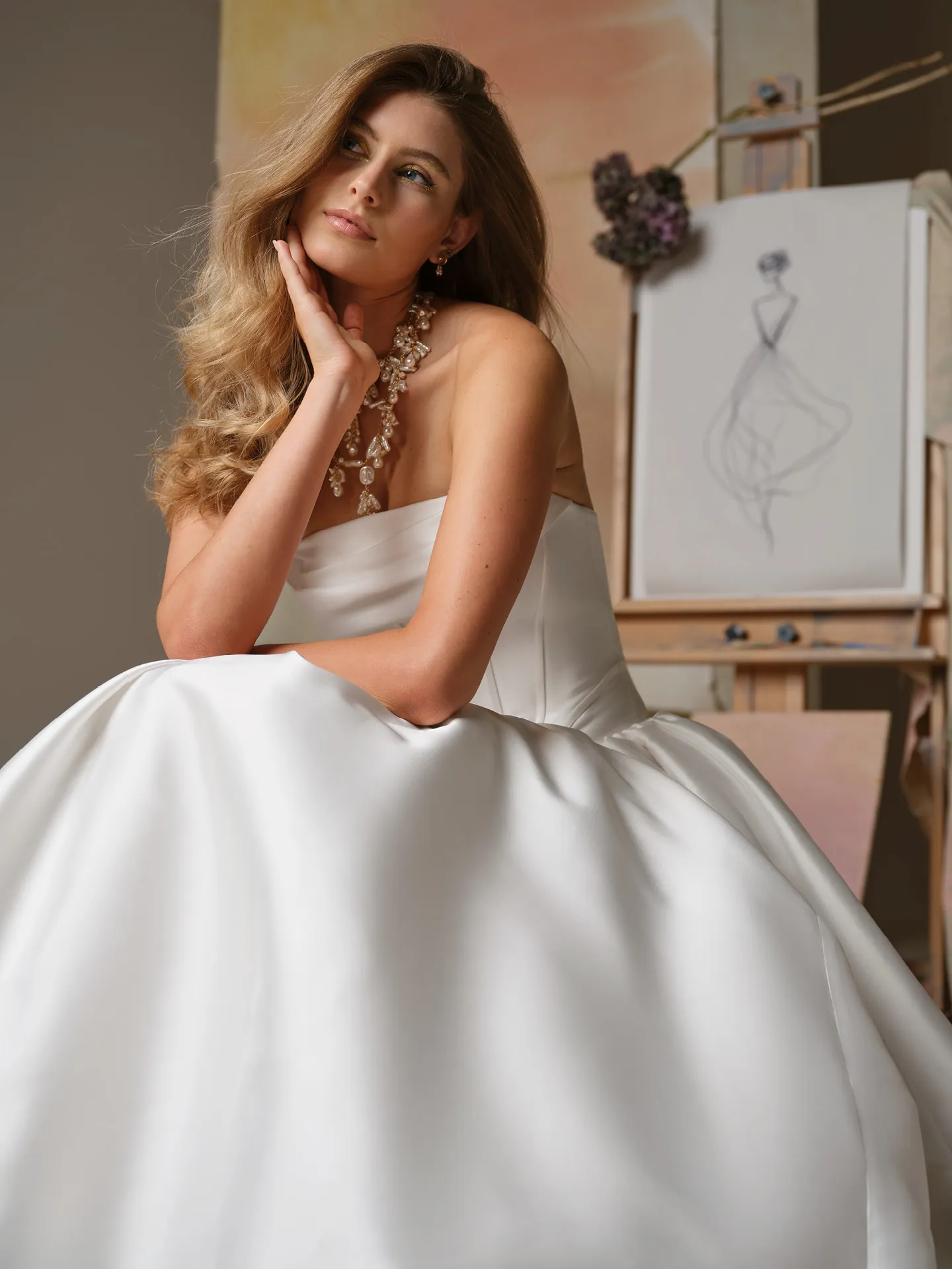 Maggie Sottero Yuma ballgown, front view with cowl neck and basque waist in artistic setting.