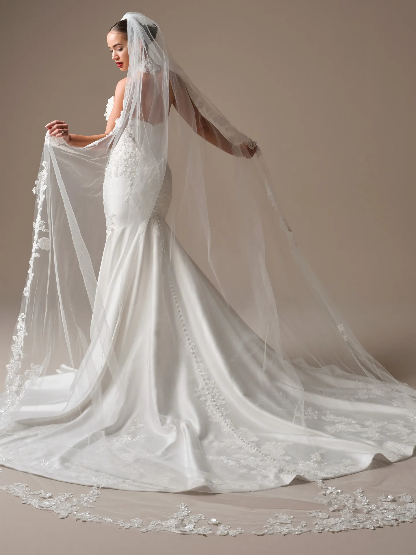 Maggie Sottero Burke fit-and-flare, back view with long lace train.