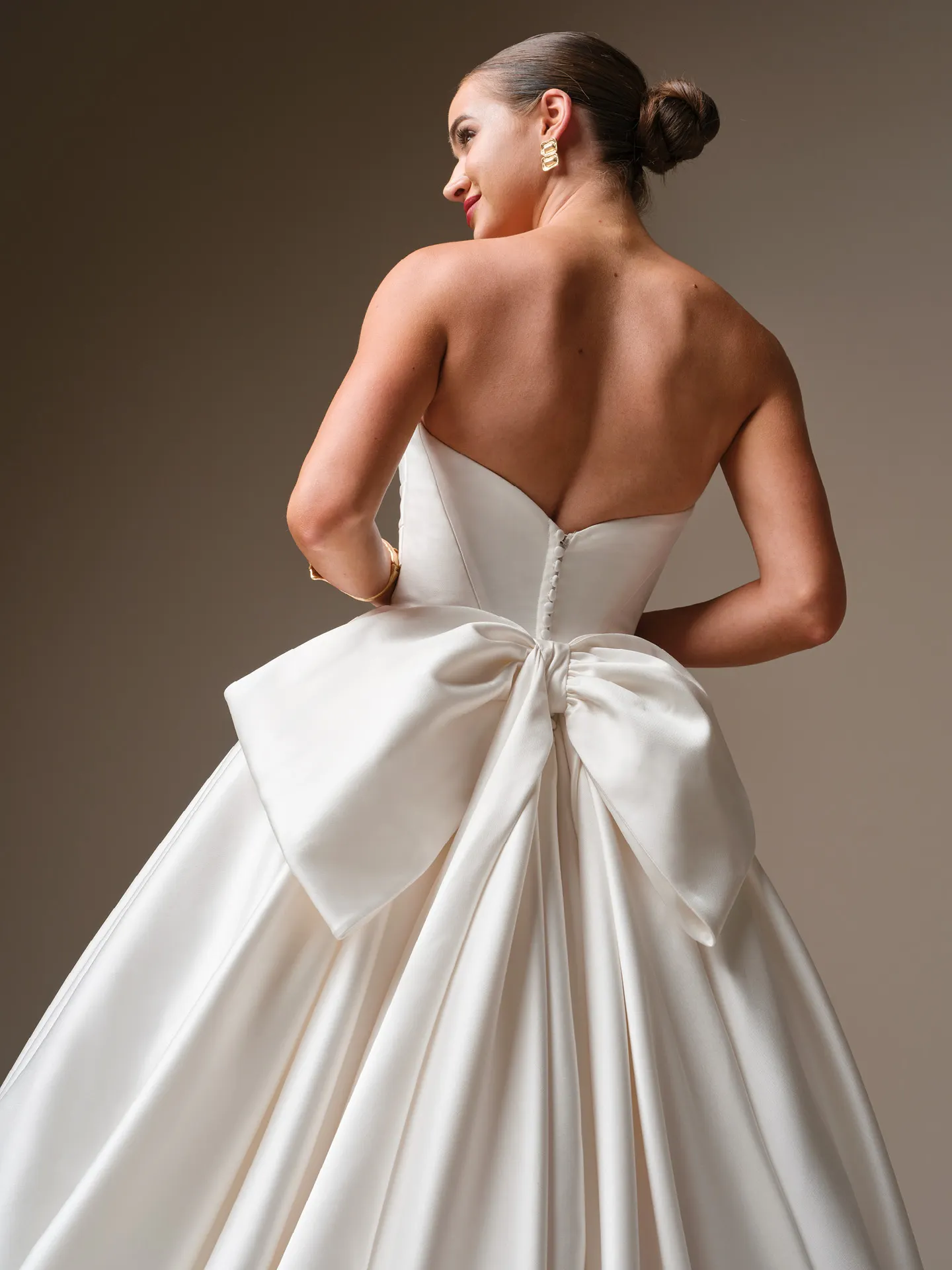 Sottero and Midgley Elias, back view satin ballgown with large bow.
