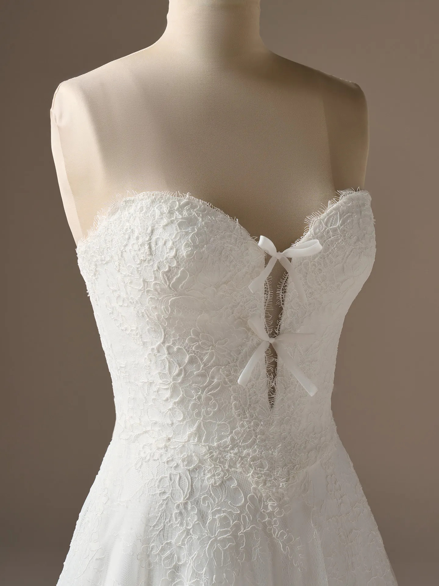 Sottero and Midgley Granger, front view lace A-line wedding dress with bow detail.