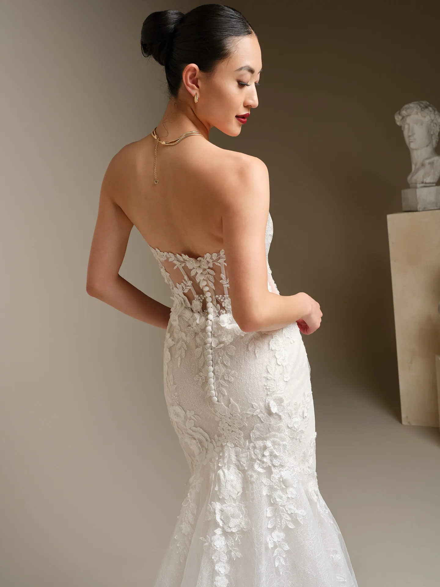 Sottero and Midgley Rashida, back view lace fit-and-flare wedding dress.