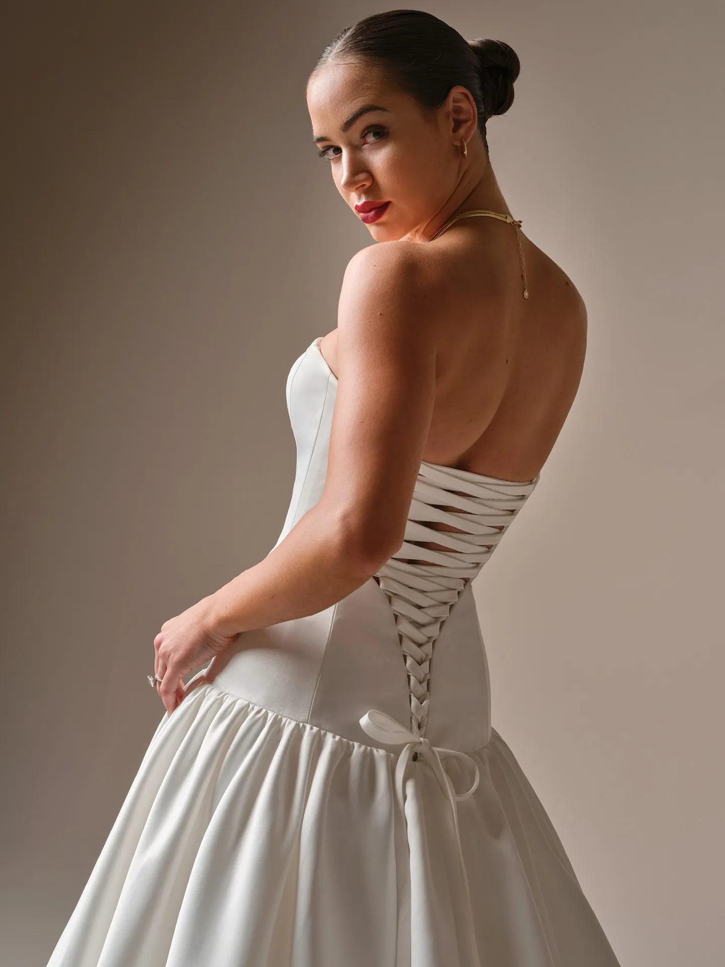 Sottero and Midgley Tokyo, side view strapless satin lace-up corset ballgown.