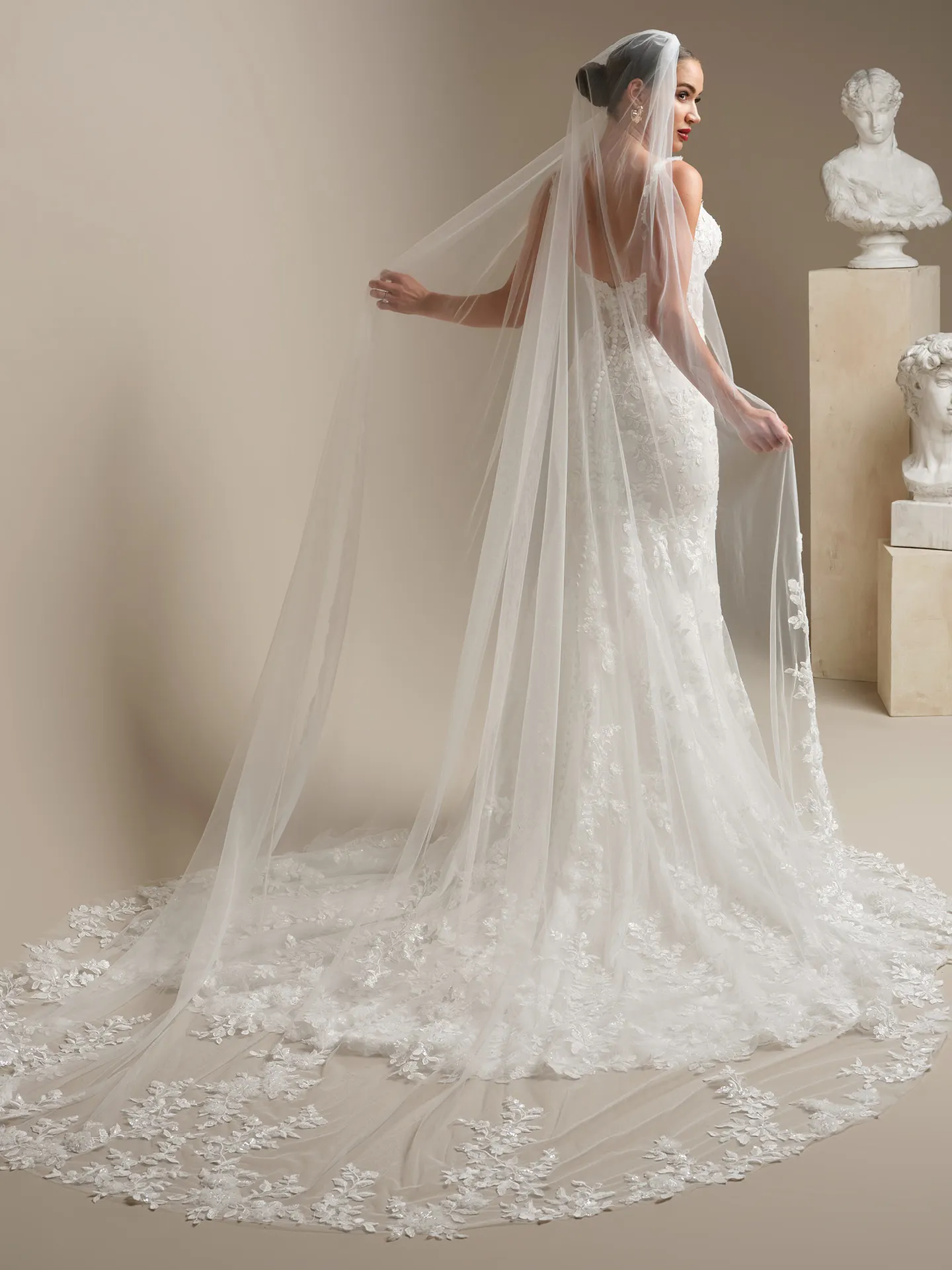 Sottero and Midgley West, back view lace fit-and-flare wedding dress with chapel-length veil.
