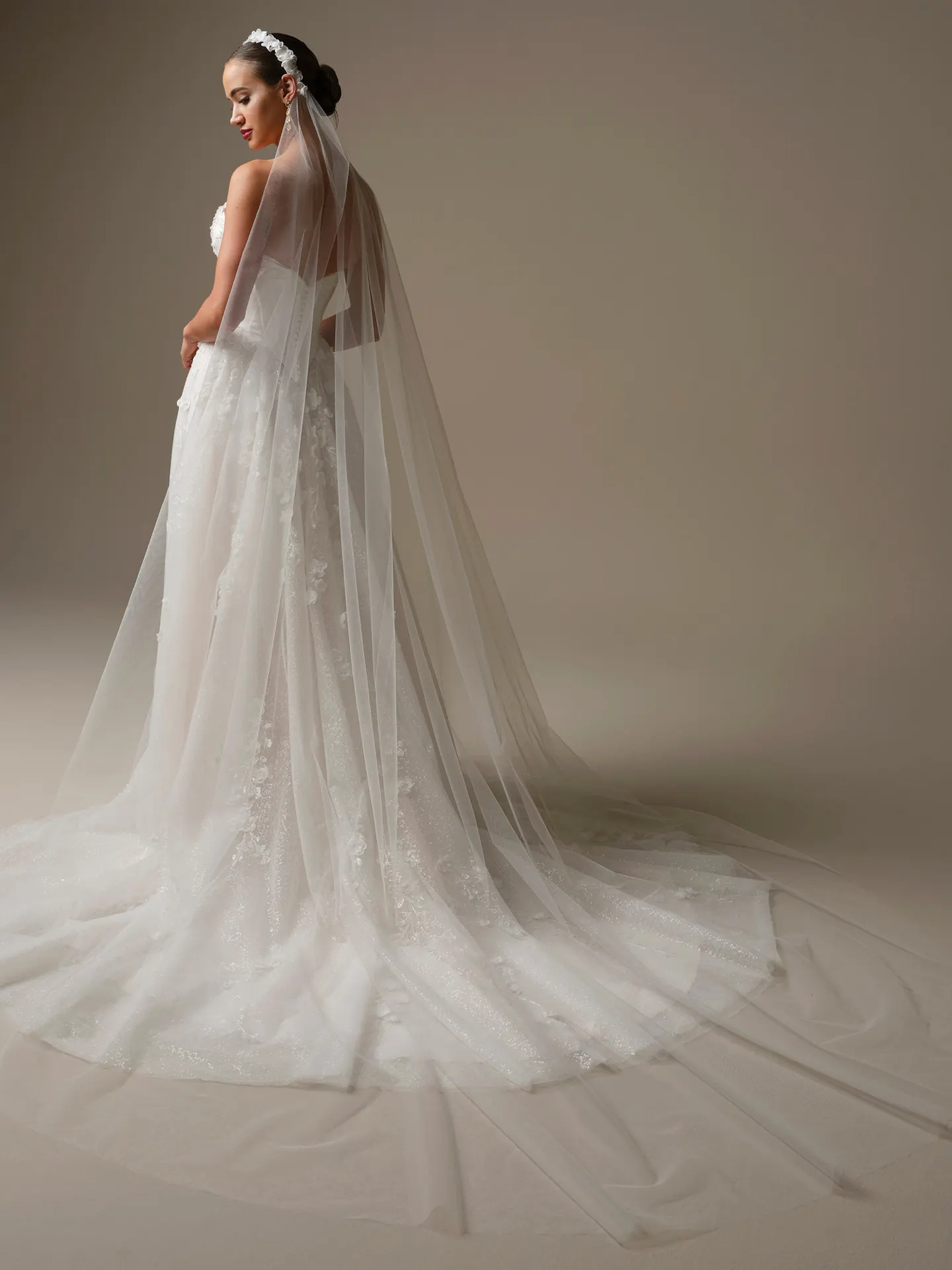 Sottero and Midgley Kalinda, side view, with cathedral veil and 3-D flower headband.
