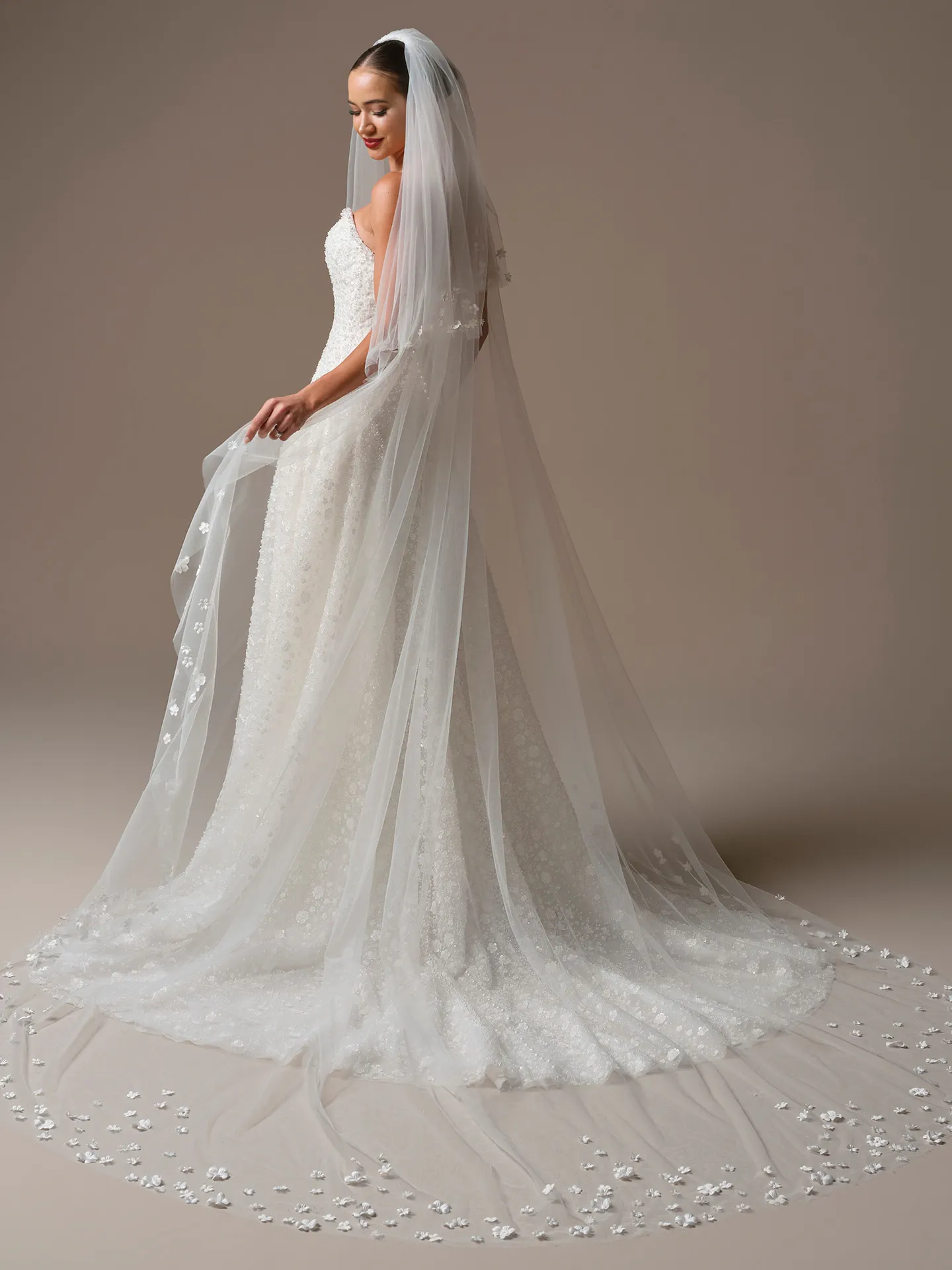 Sottero and Midgley Marceline, back view veil with scattered 3-D flowers over lace dress.