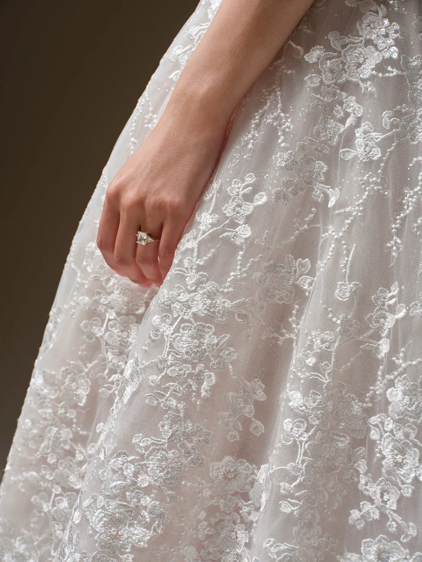 Maggie Sottero Memphis wedding dress detail with floral lace and ring.