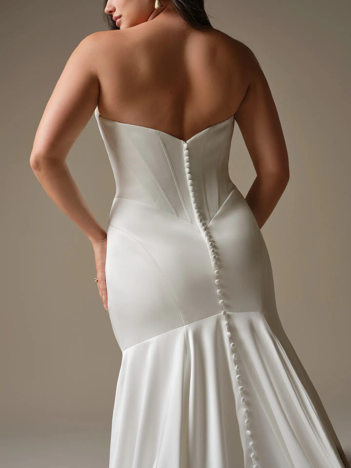 Maggie Sottero Sinclaire, back view, cat eye sheath wedding dress with button detail.