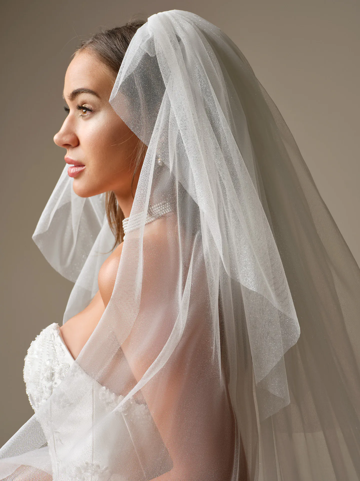 Maggie Sottero Wyntelle, side view with veil lace fit-and-flare dress Maggie Sottero.