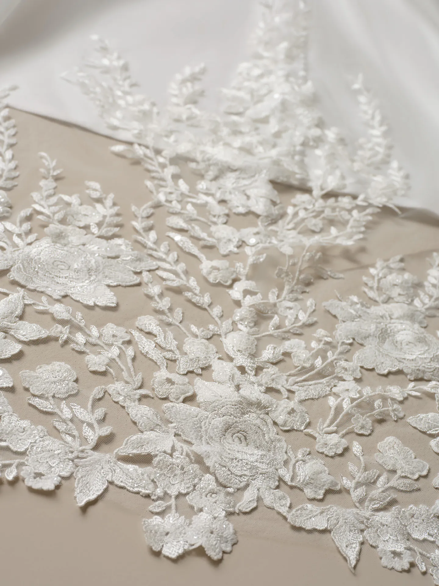Maggie Sottero Yuma lace detail on a ballgown wedding dress fabric.