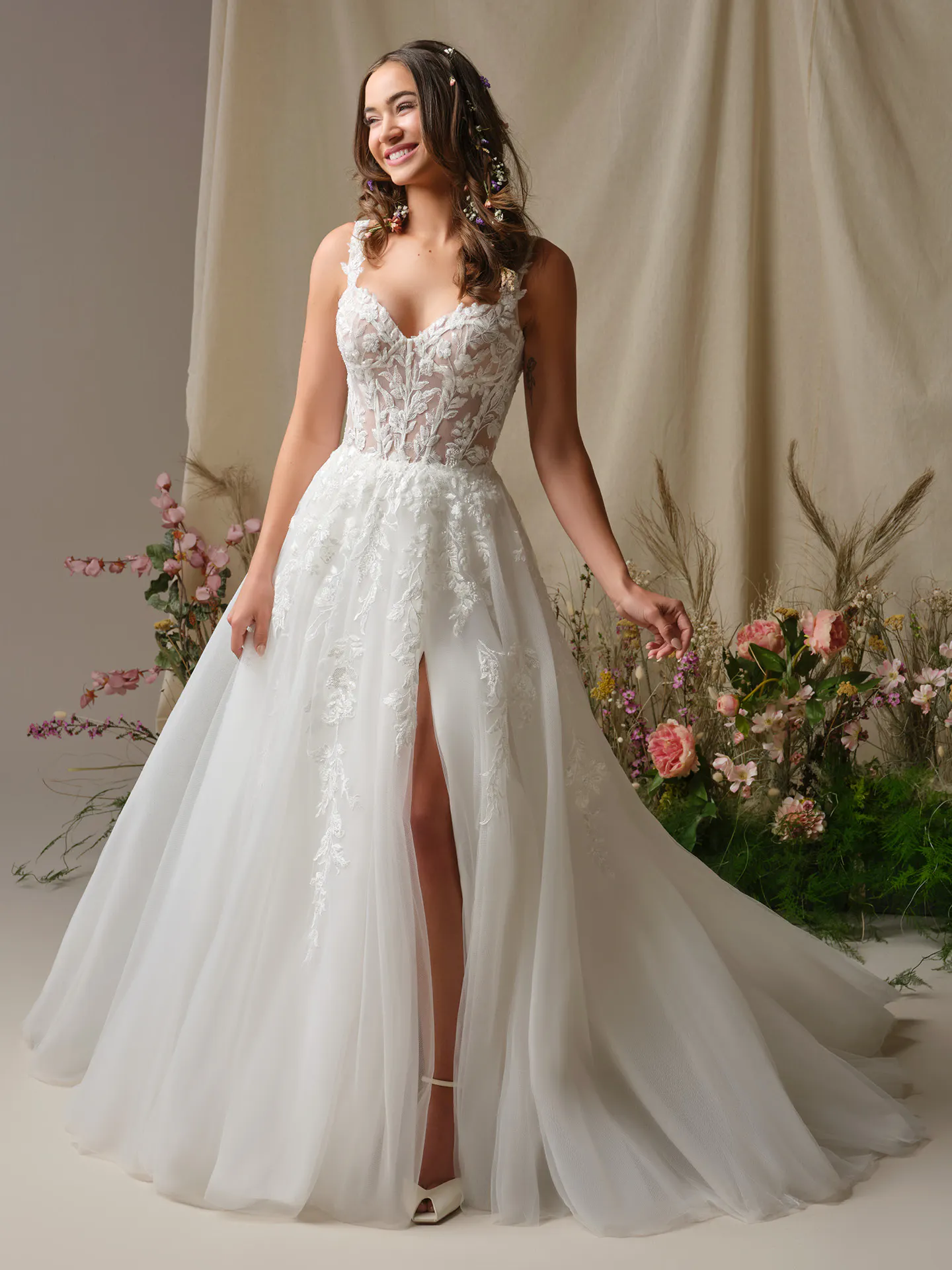 Rebecca Ingram Susan front view ballgown with illusion bodice and floral background