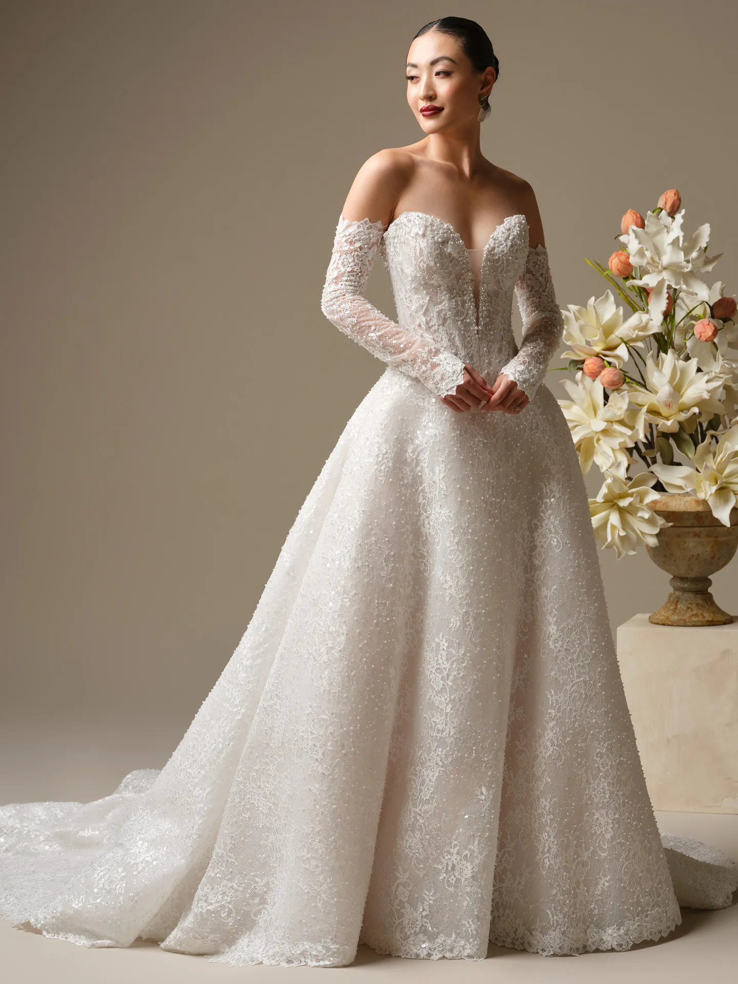 Maggie Sottero Angelica A-Line wedding dress side view with floral background.