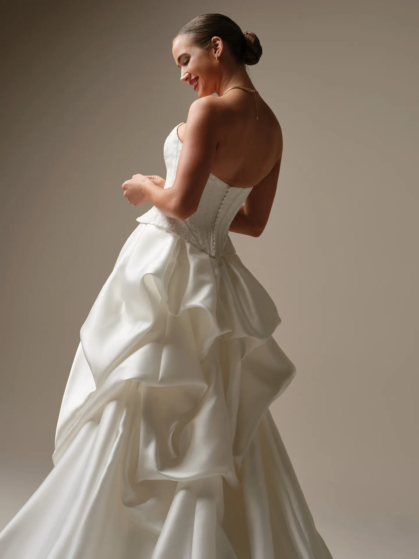 Sottero and Midgley strapless white dress, side view with layered skirt detailing.