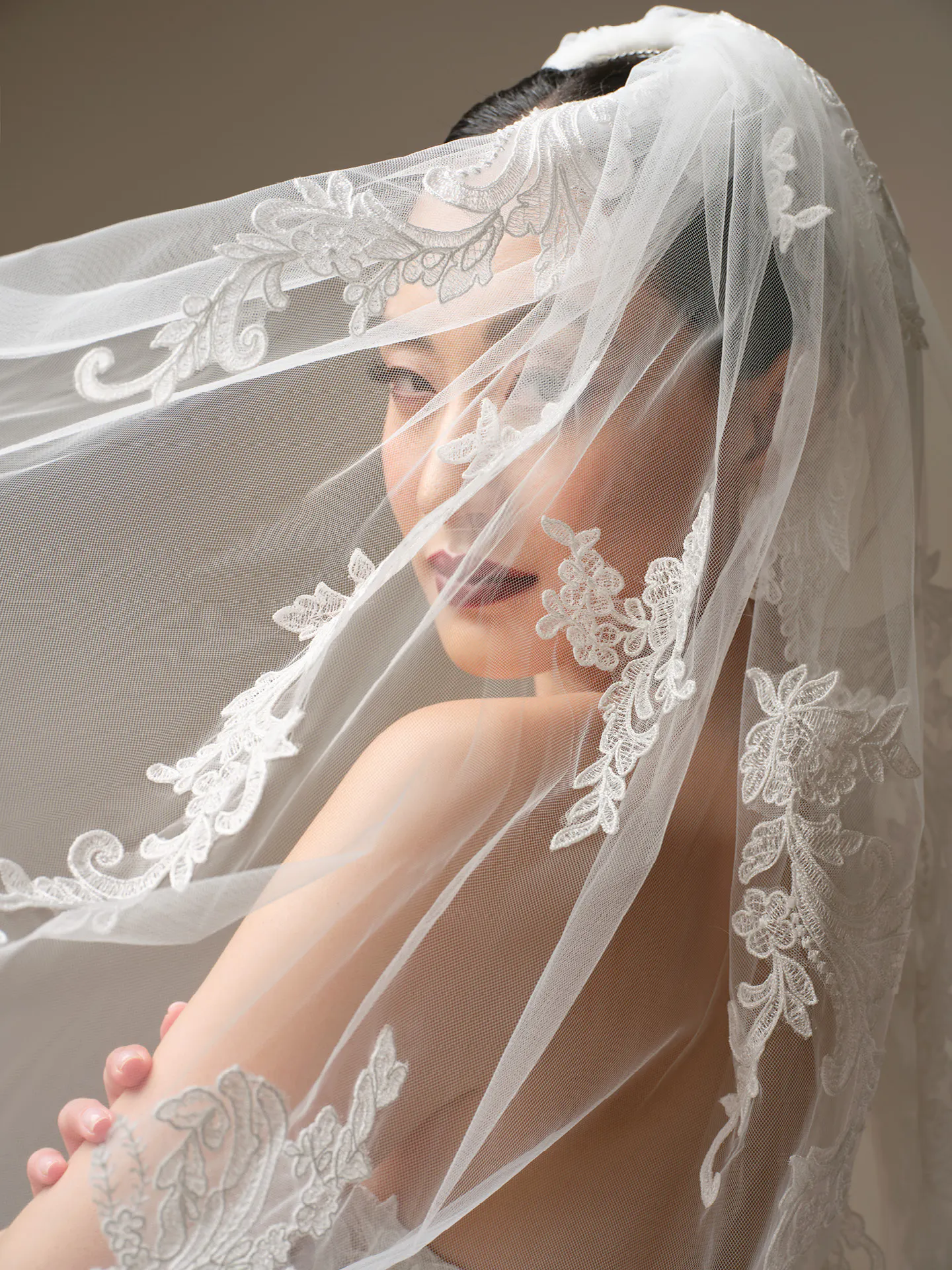 Sottero and Midgley Zulani veil with sequin lace detailing draped elegantly over the shoulder.