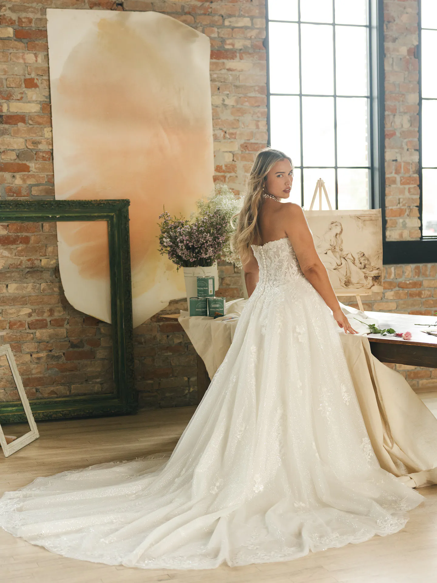 Maggie Sottero Jennifer, back view, V-neck A-line sequin wedding dress in rustic studio setting.