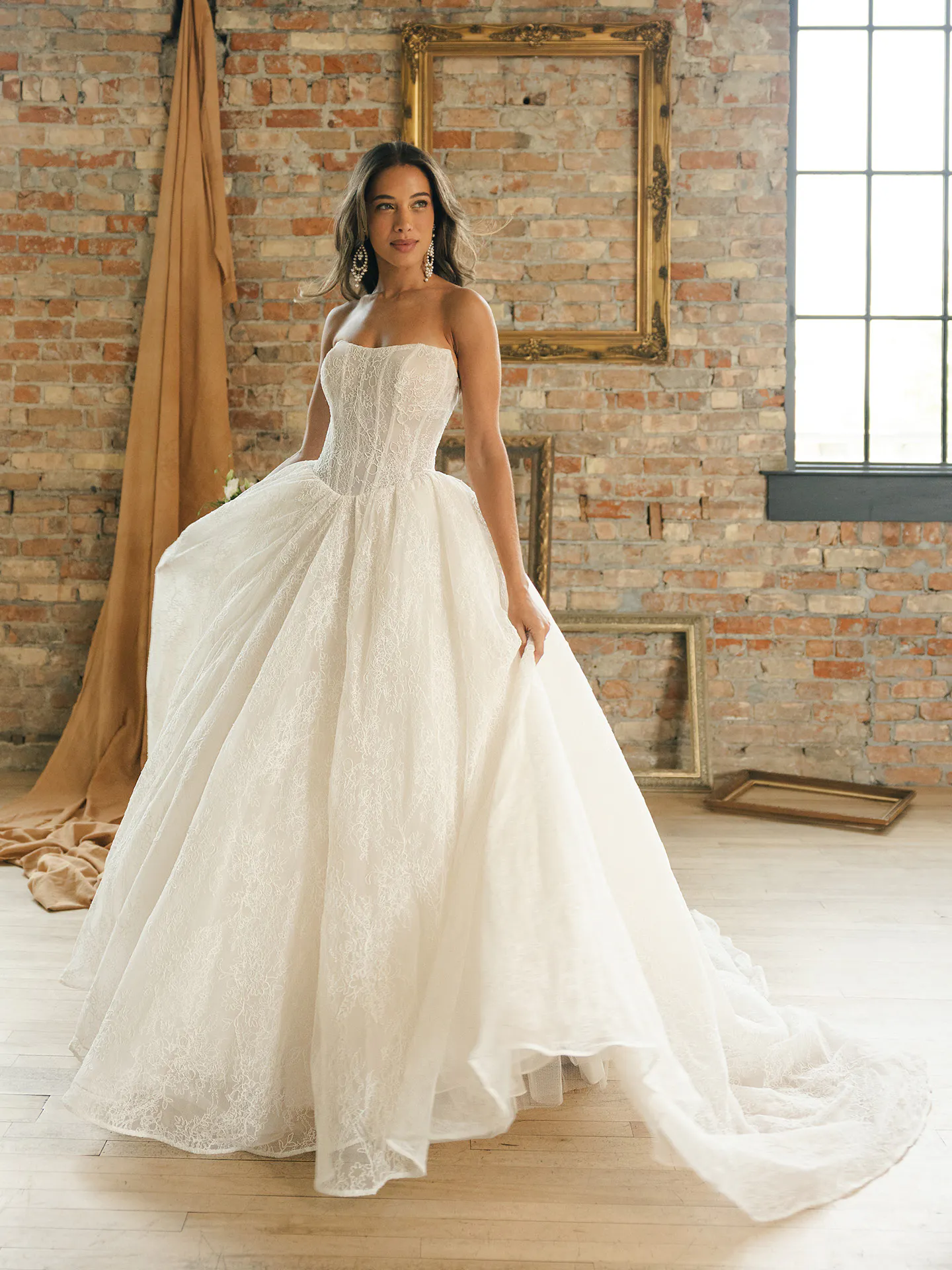 Maggie Sottero Raquel, front view lace ballgown wedding dress in rustic room.