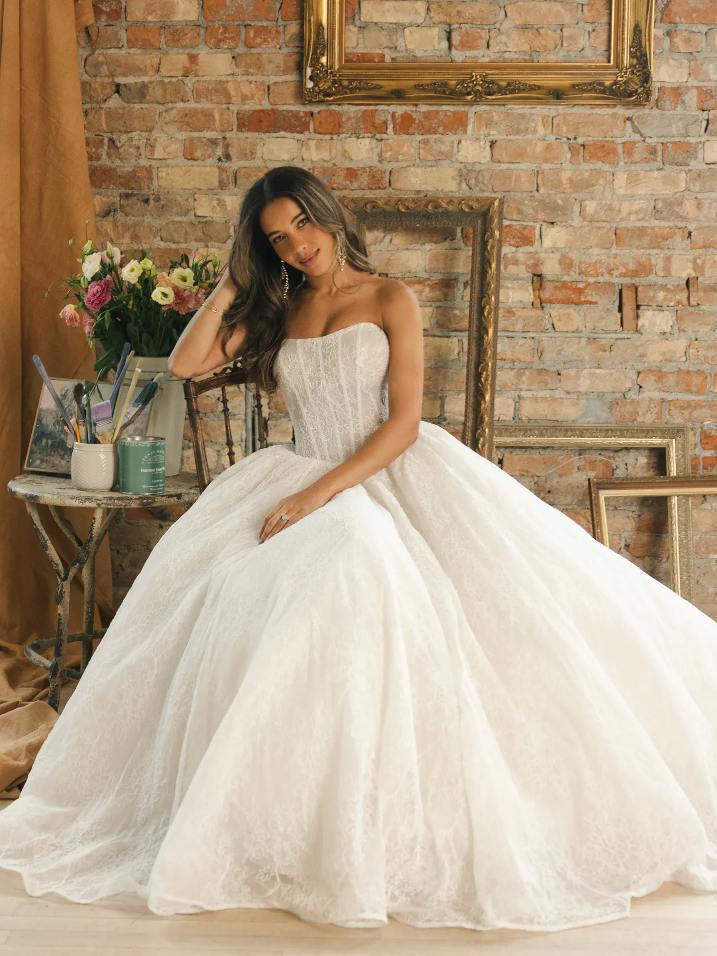 Raquel Chantilly lace ballgown, front view, Maggie Sottero, floral bricks background.