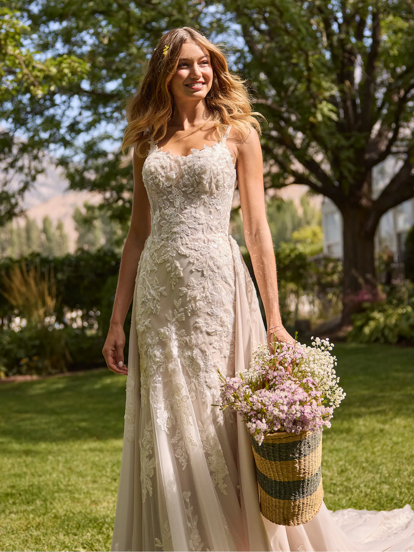 Rebecca Ingram Eden fit-and-flare wedding dress, front view with lace detail in garden setting.