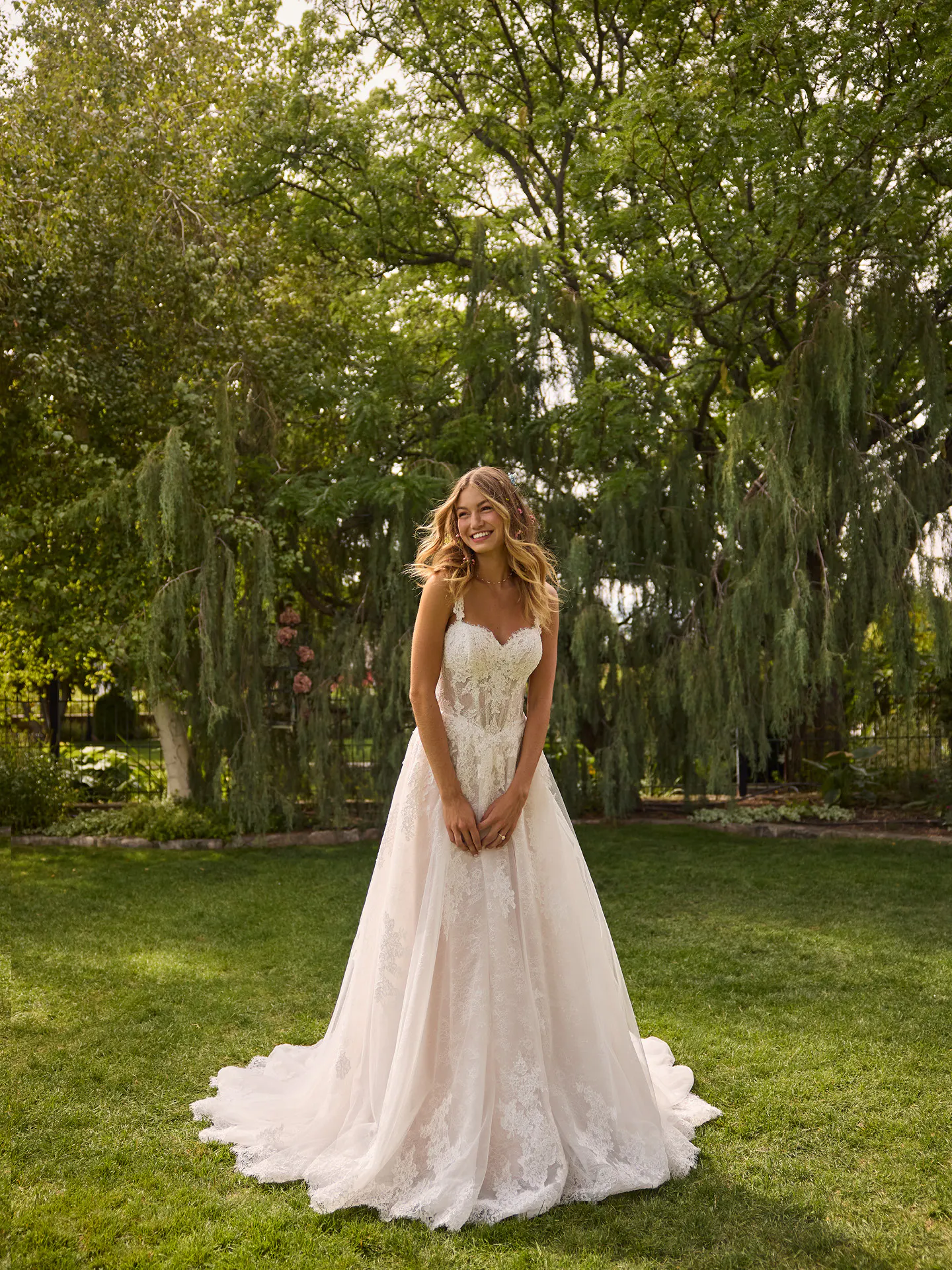 Rebecca Ingram Esmeralda lace A-line wedding dress front view in garden setting