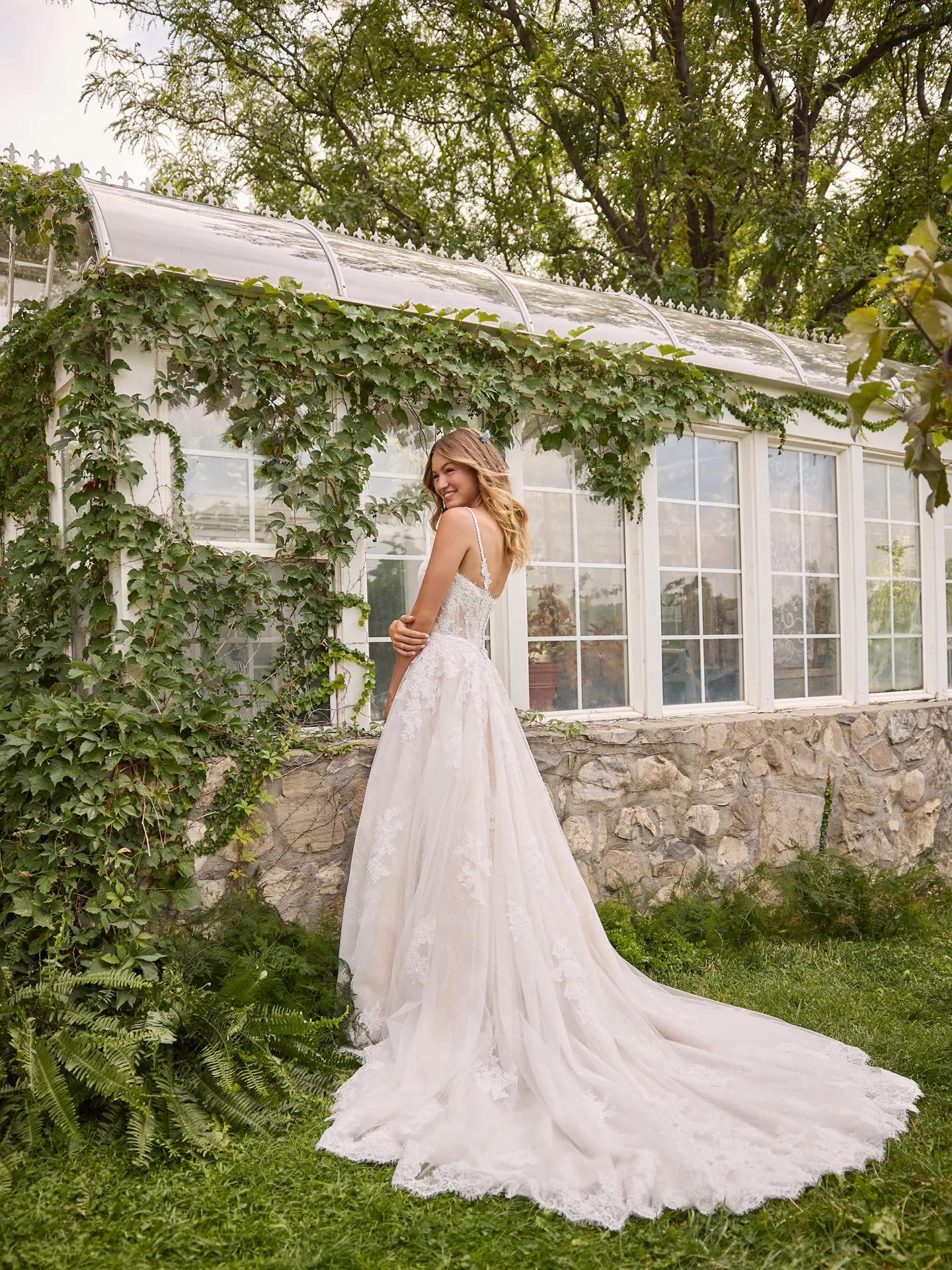 Rebecca Ingram Esmeralda back view, sweetheart neckline, lace A-line dress in garden setting