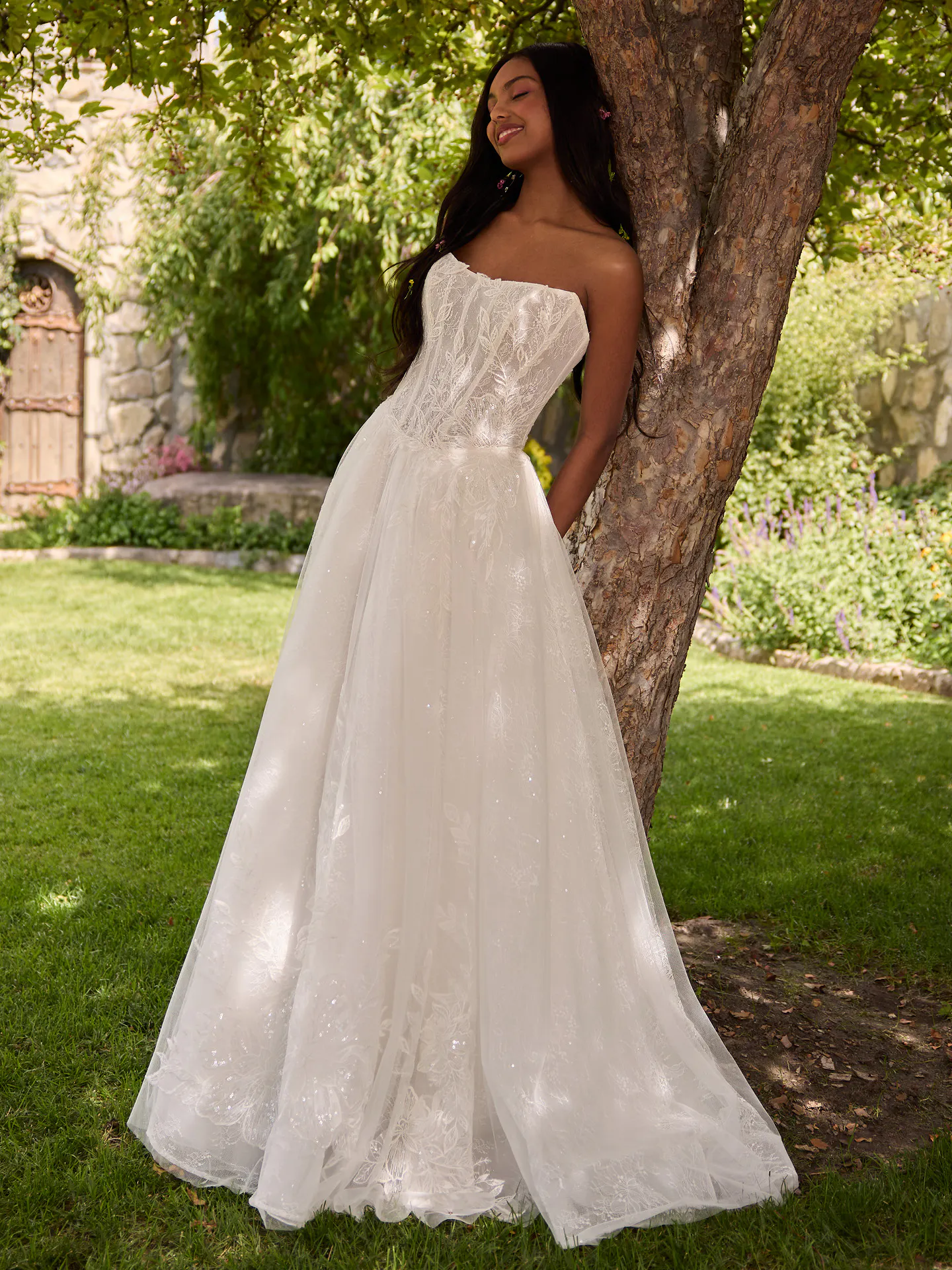 Rebecca Ingram Lisa front view lace ballgown wedding dress under a tree