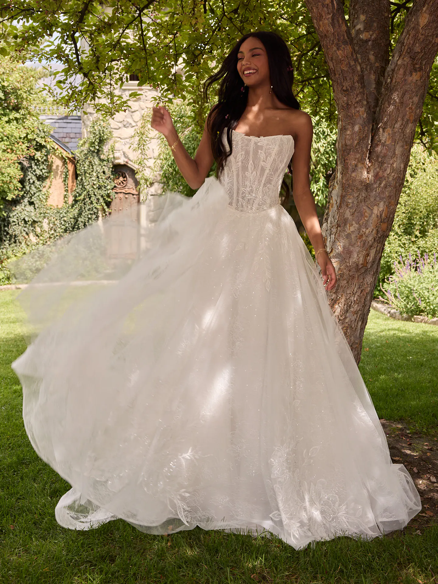 Rebecca Ingram Lisa front view, cat eye illusion lace ballgown in garden setting