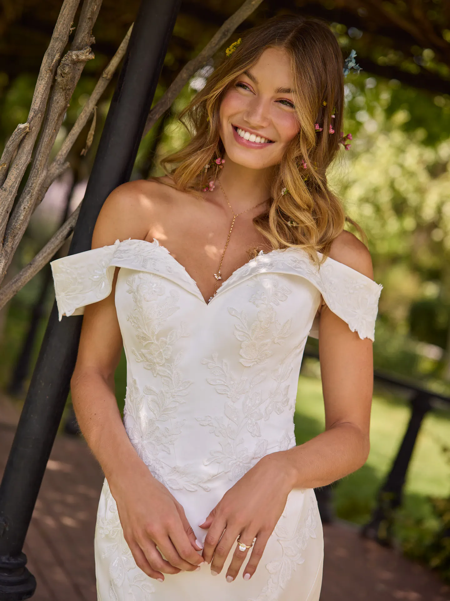 Rebecca Ingram Miley front view, off-the-shoulder sequined lace dress in garden setting