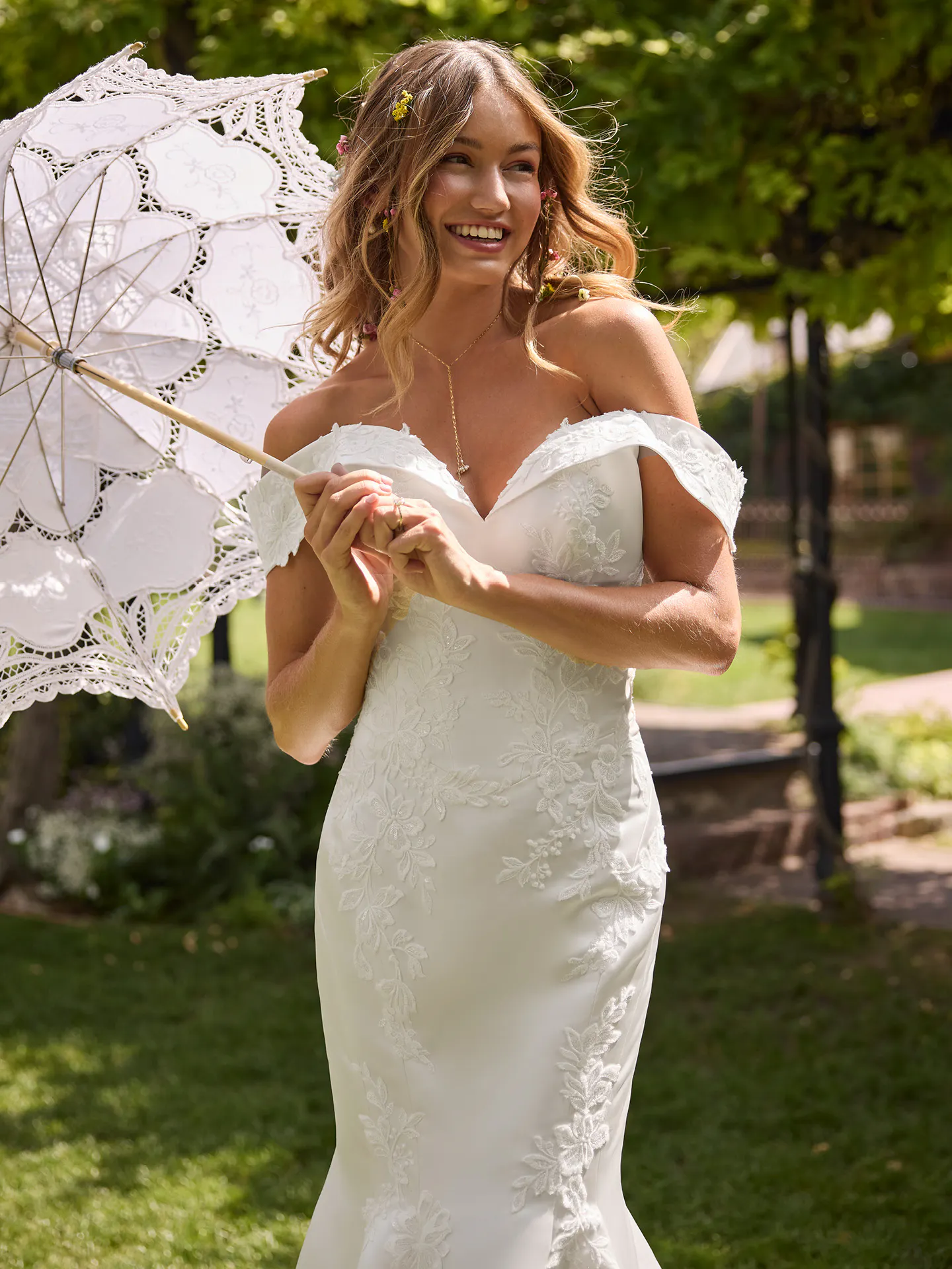 Rebecca Ingram Miley front view in garden, off-shoulder lace fit-and-flare wedding dress
