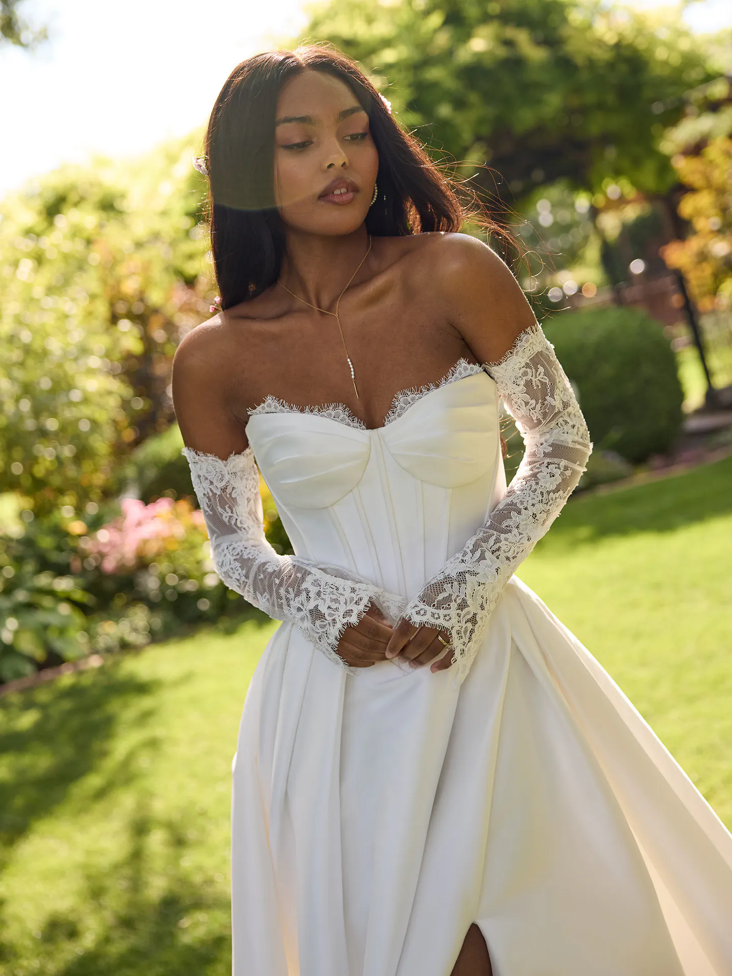 Rebecca Ingram Zorina front view lace trim mikado wedding dress in garden setting