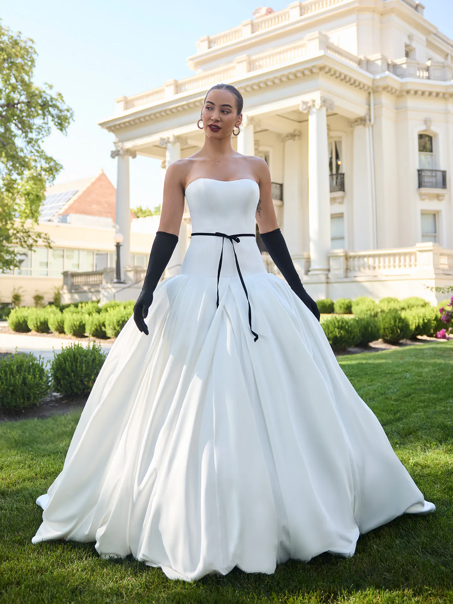 Maggie Sottero Adair, front view strapless satin ballgown with black gloves.