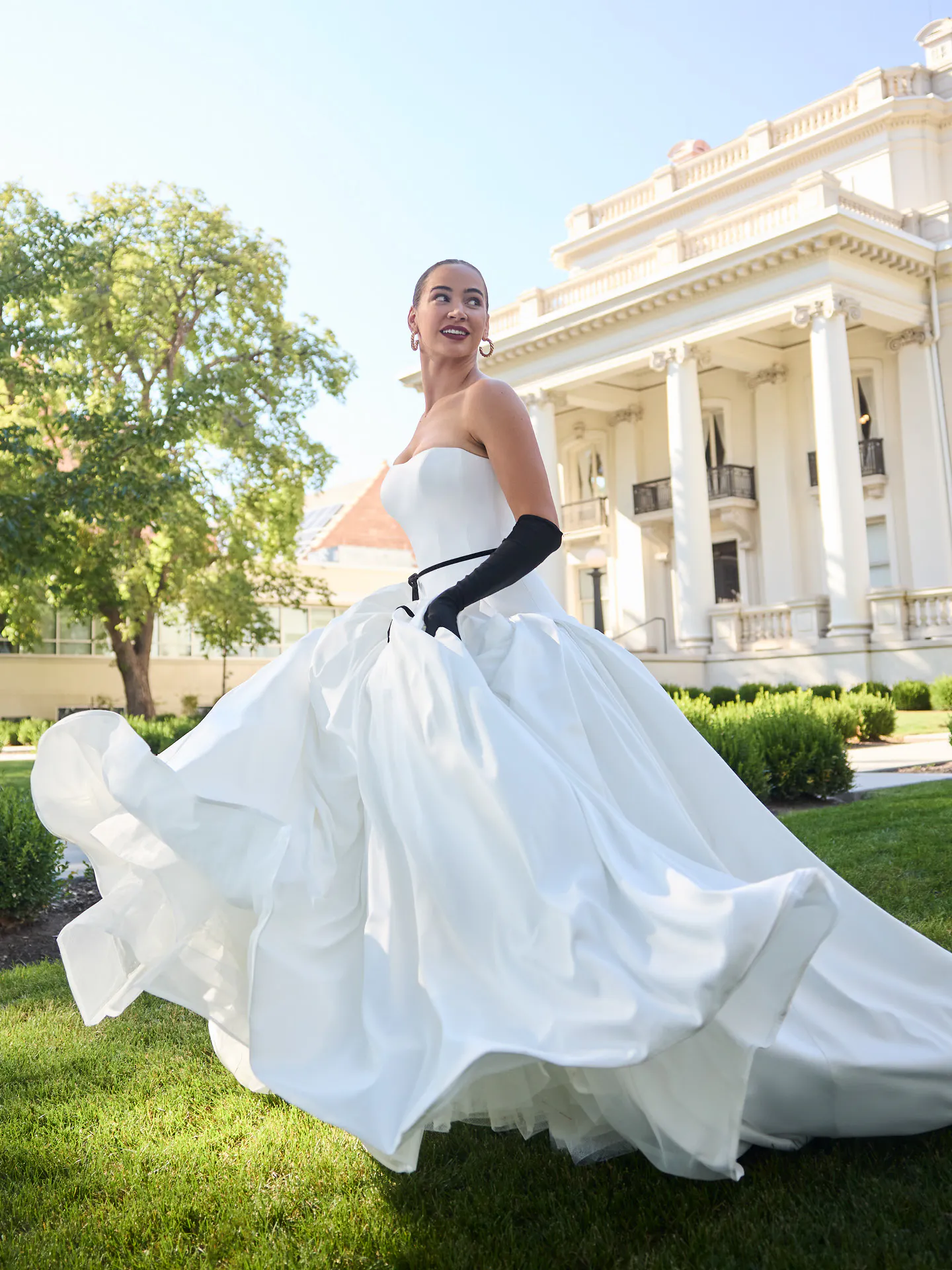 Maggie Sottero Adair strapless ballgown, front view, elegant outdoor setting.