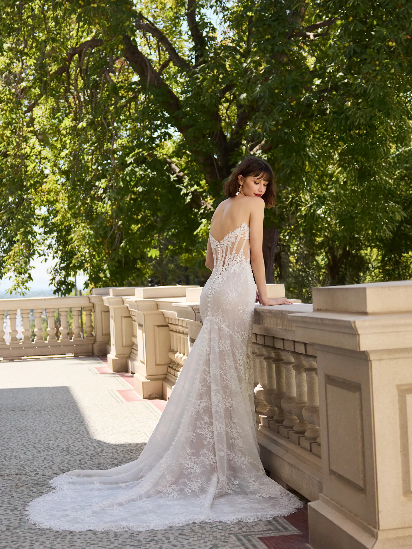 Sottero and Midgley Dublin, back view lace sheath wedding dress on terrace.