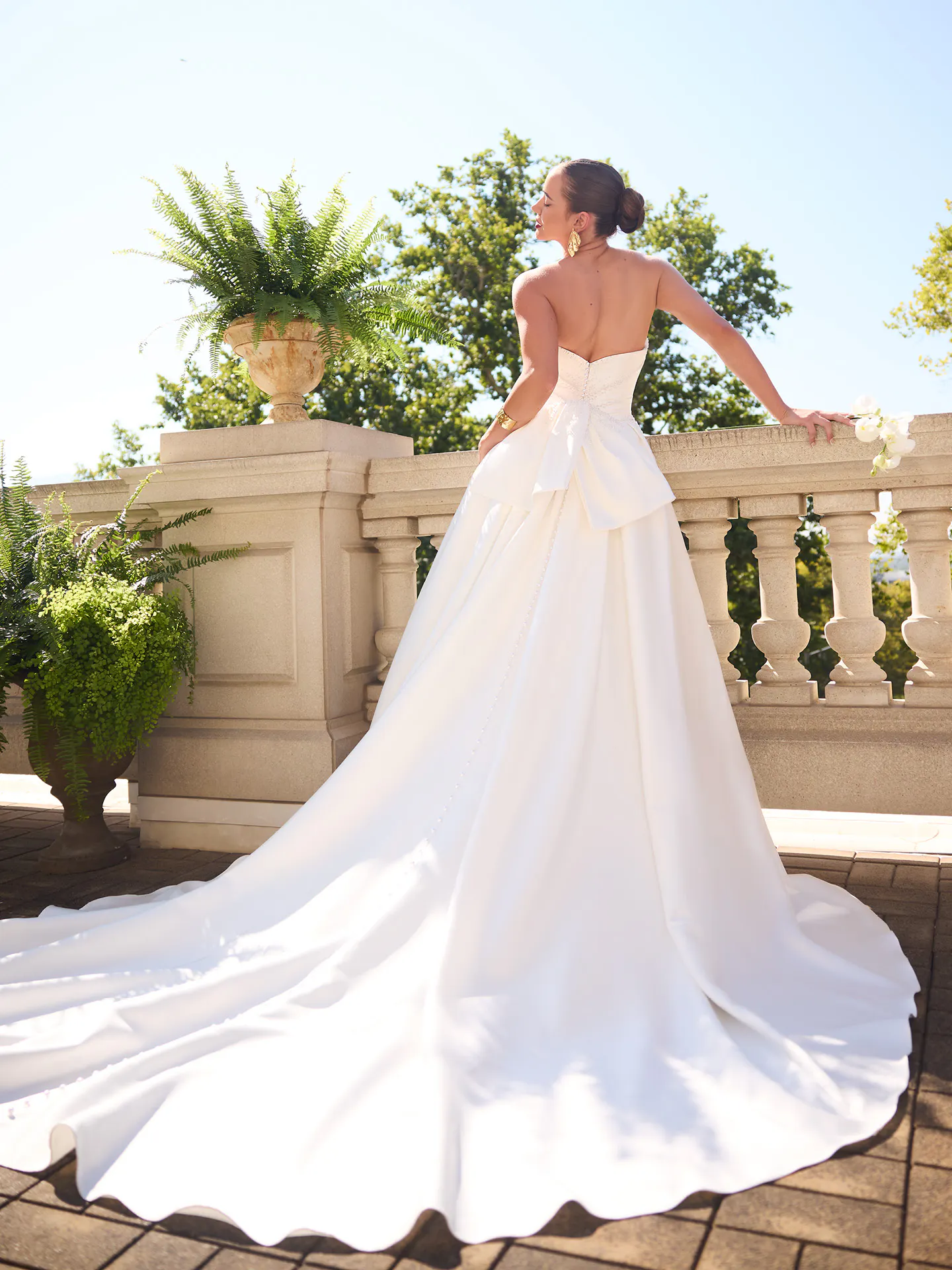 Sottero and Midgley Kincaid satin ballgown, back view on terrace.