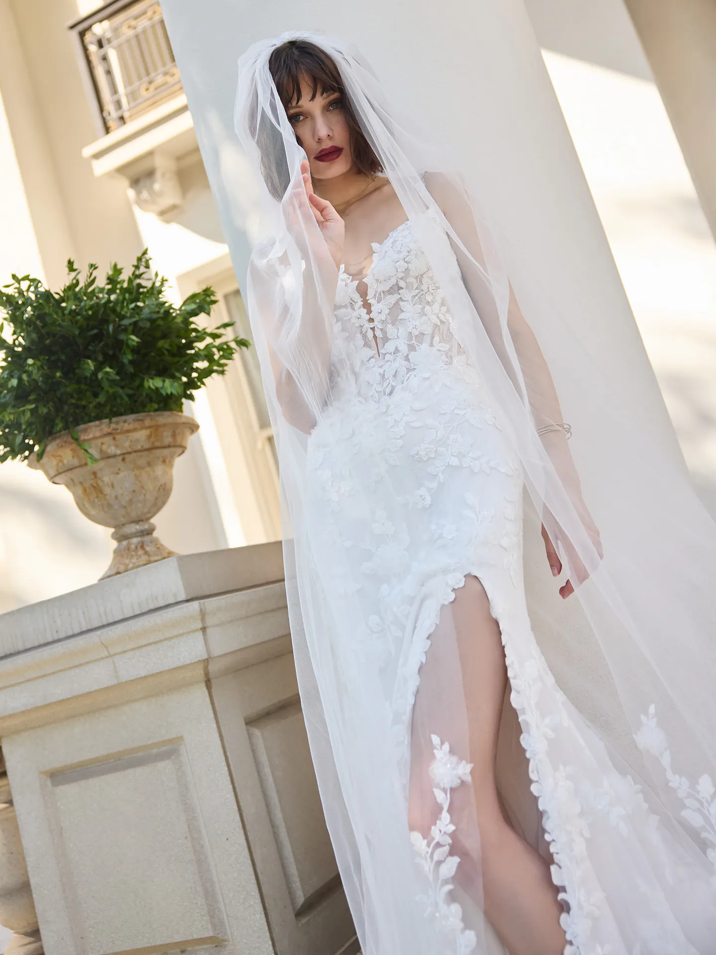 Sottero and Midgley West, front view lace fit-and-flare wedding dress with slit.