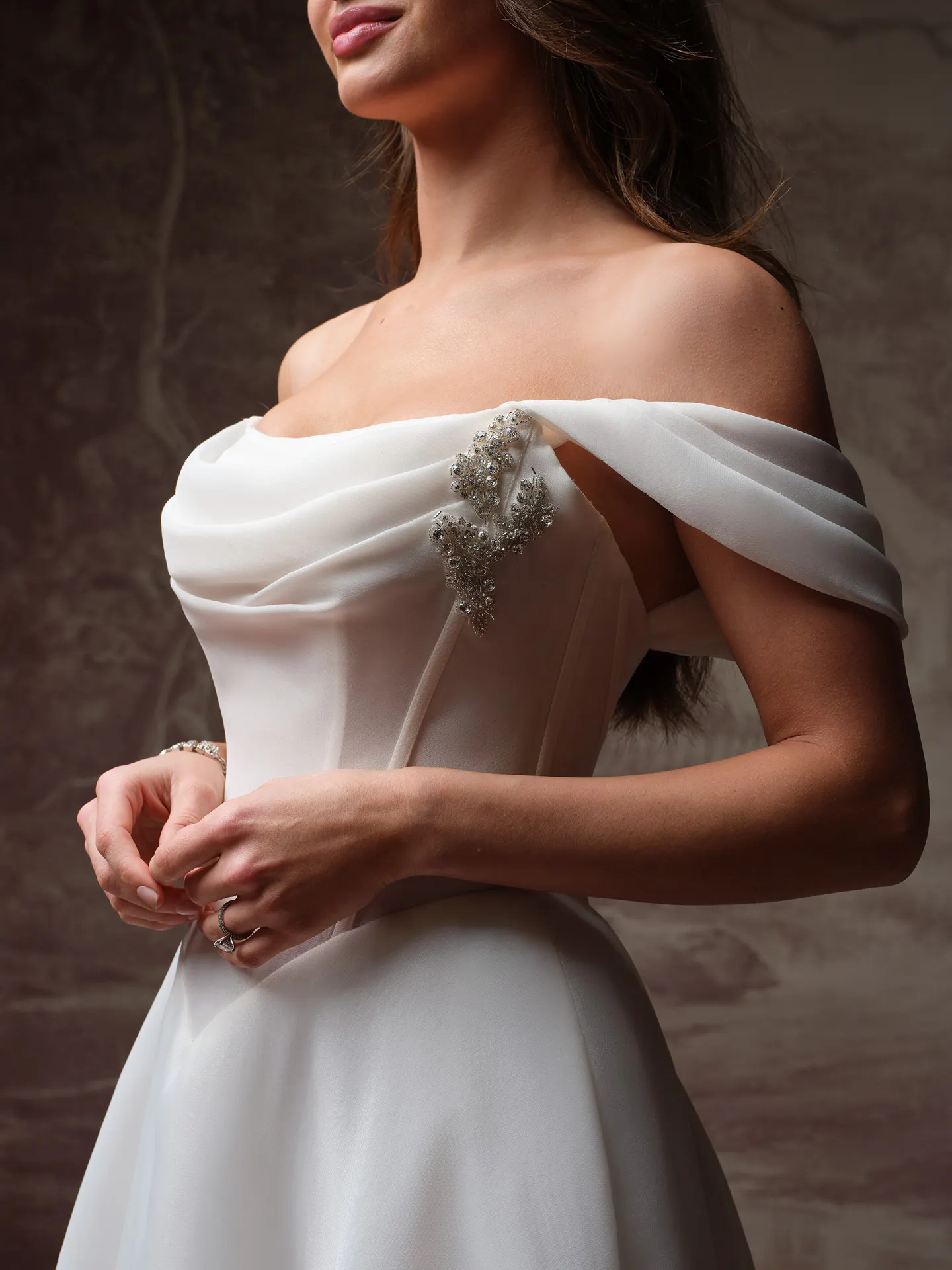 Maggie Sottero Abilene front view, basque waist, organza bodice with floral embellishments.