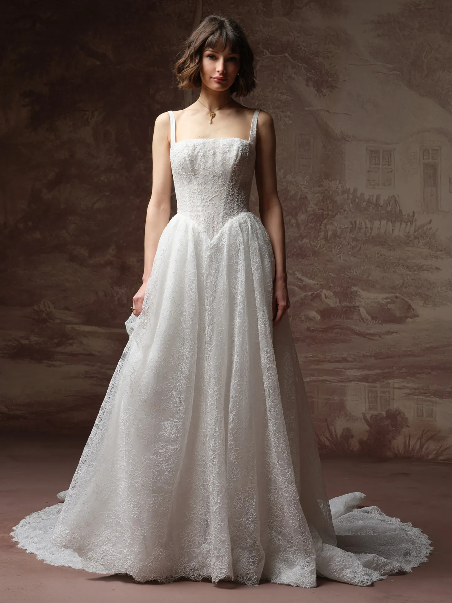 Maggie Sottero Autumn front view A Line lace wedding dress with straps, rustic backdrop.