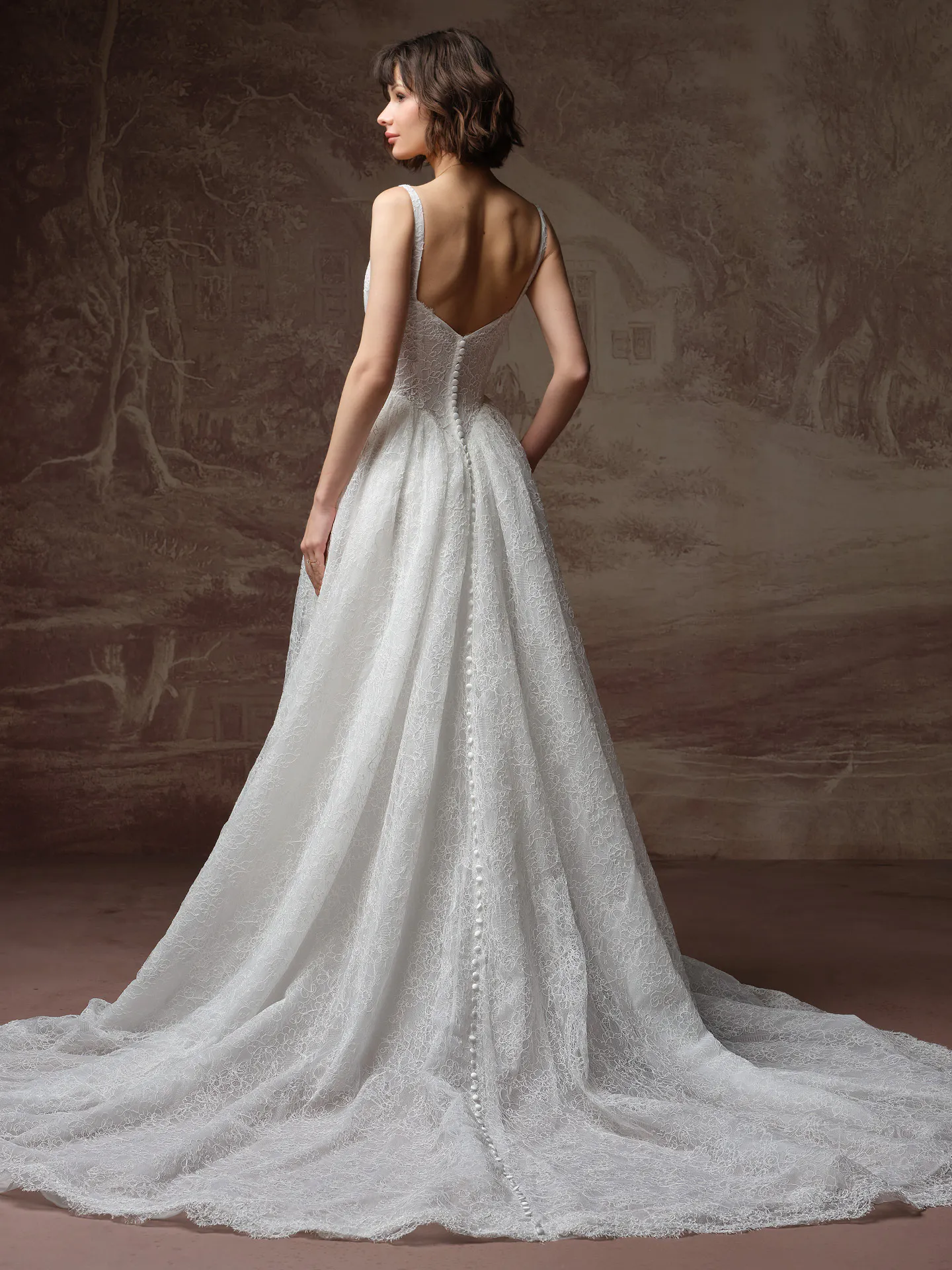 Maggie Sottero Autumn back view A Line lace dress with basque waist and button detail.