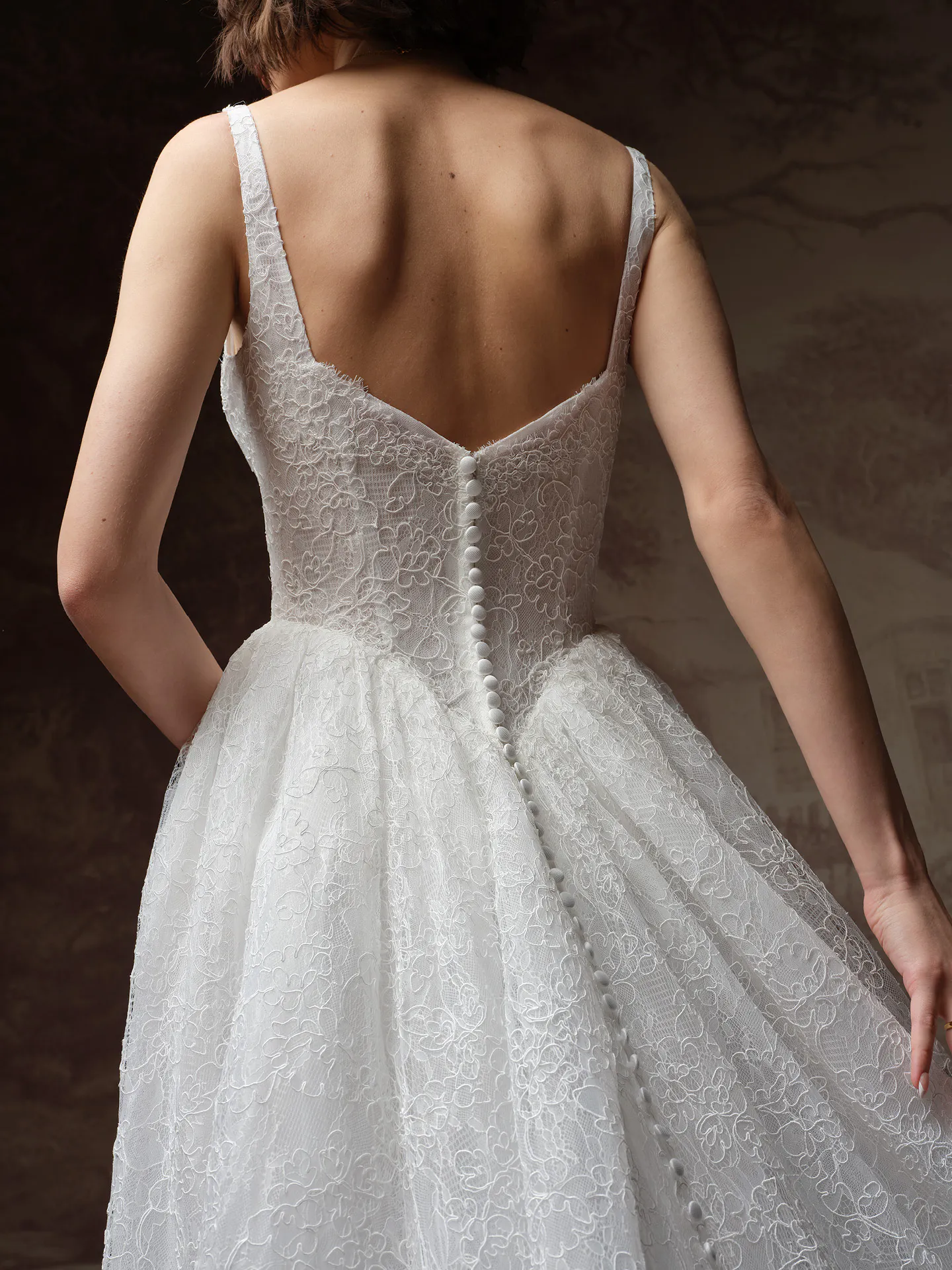 Maggie Sottero Autumn back view lace A Line dress with buttons running down the back.